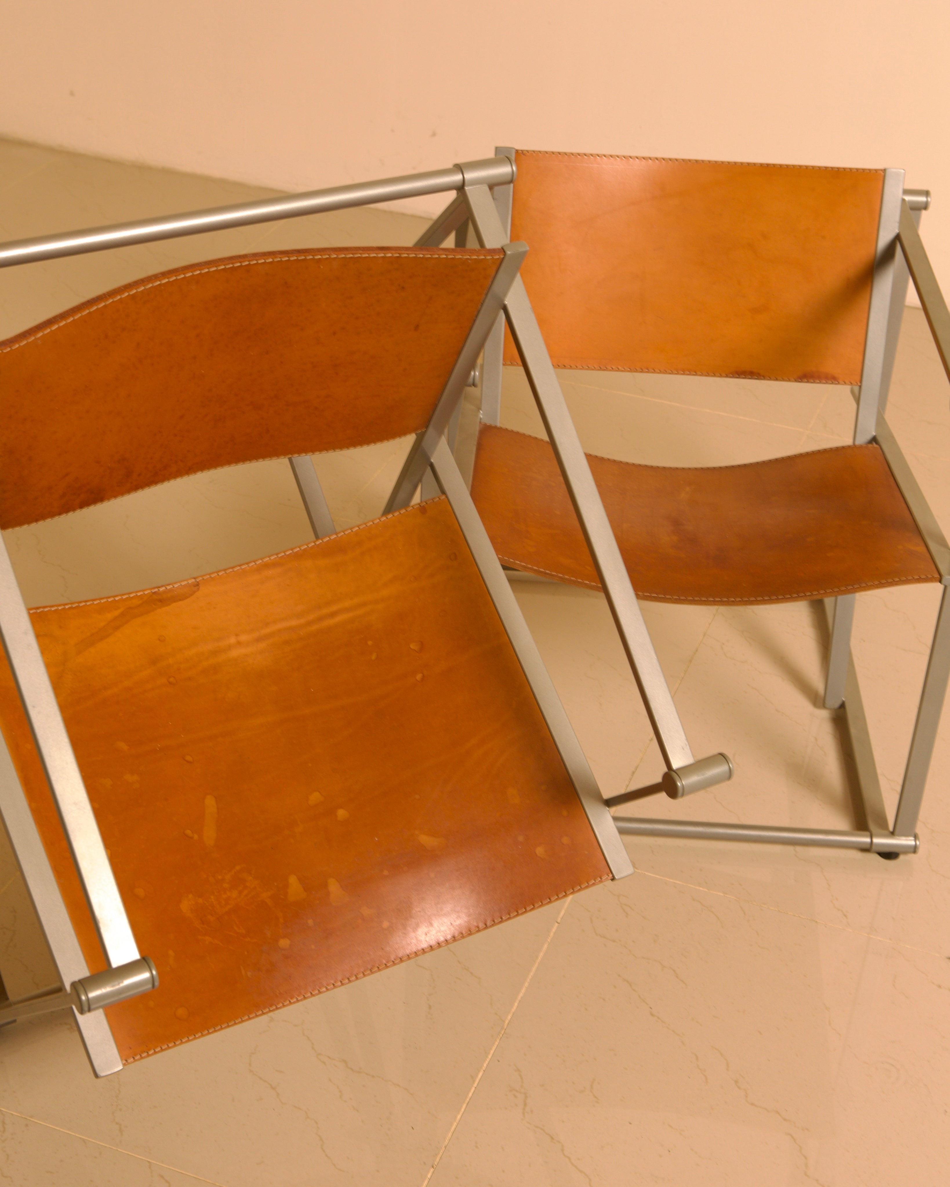 Pair of "FM62" Armchairs by Radboud van Beekum for Pastoe, 1980s — angled view showing leather seats and metal frame