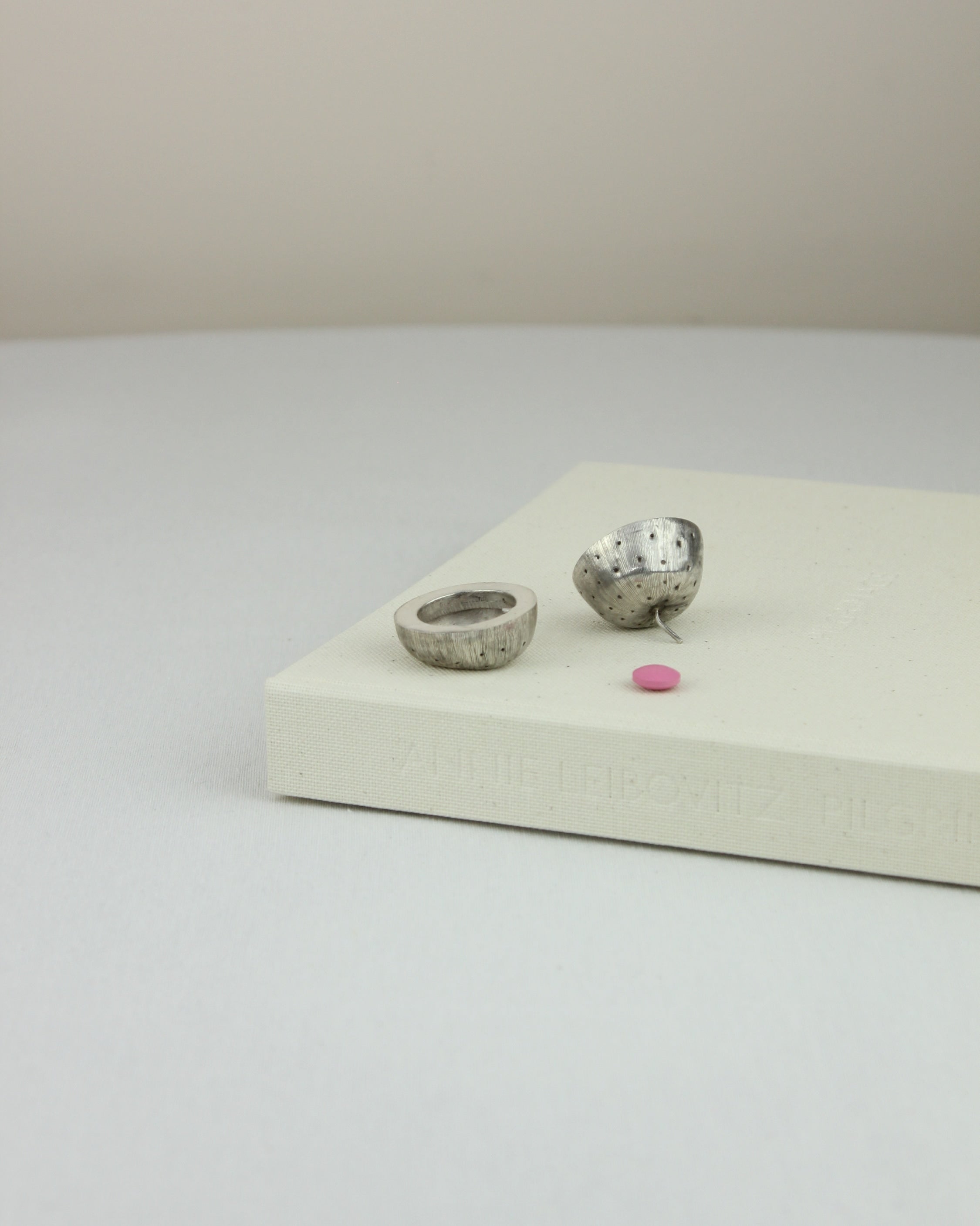 Silver Pillbox — top view on light gray surface