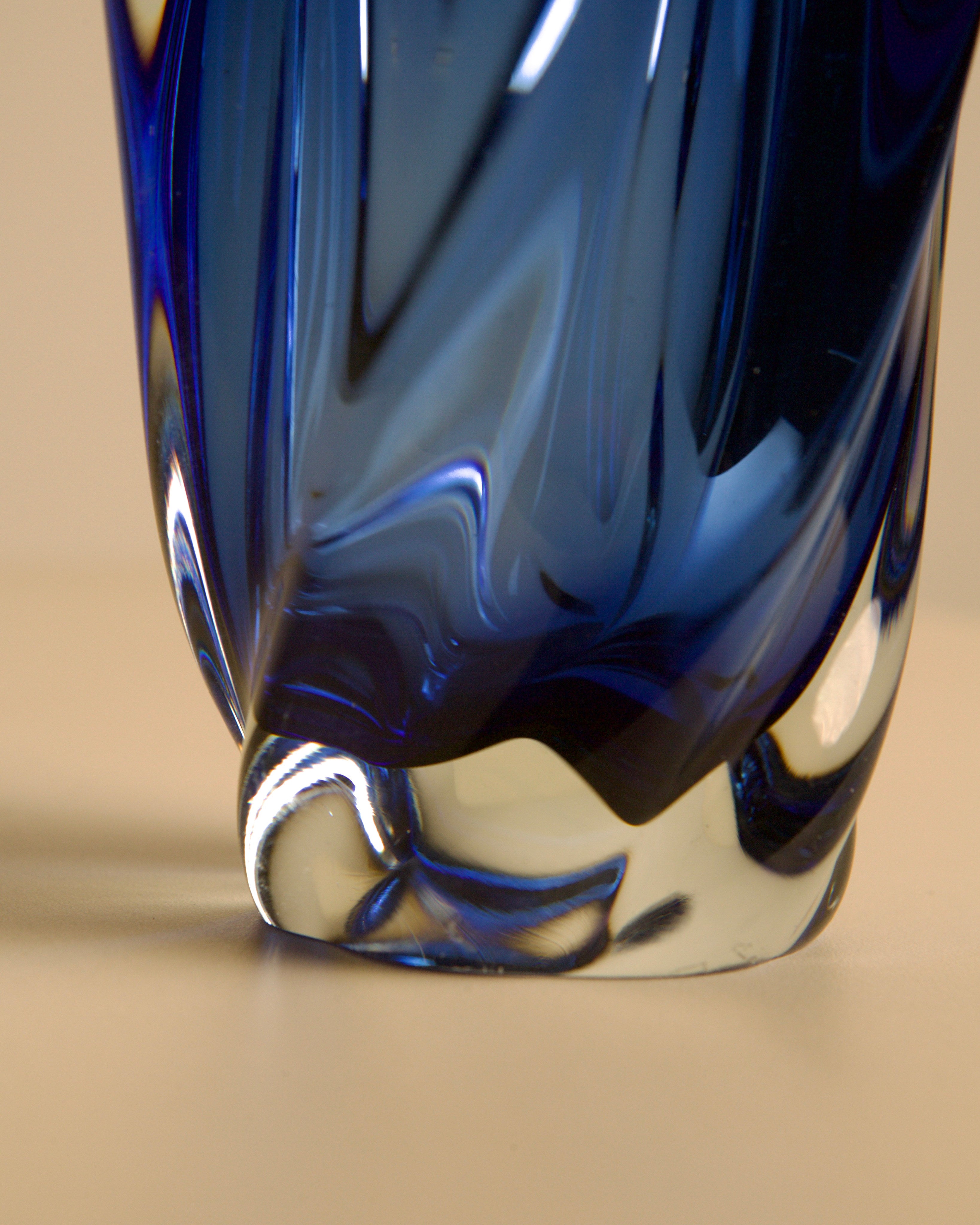 Close-up detail of blue Murano glass vase base with swirled pattern