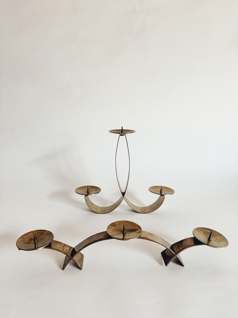 Curved brass candle holders with elegant arched design by Huerto
