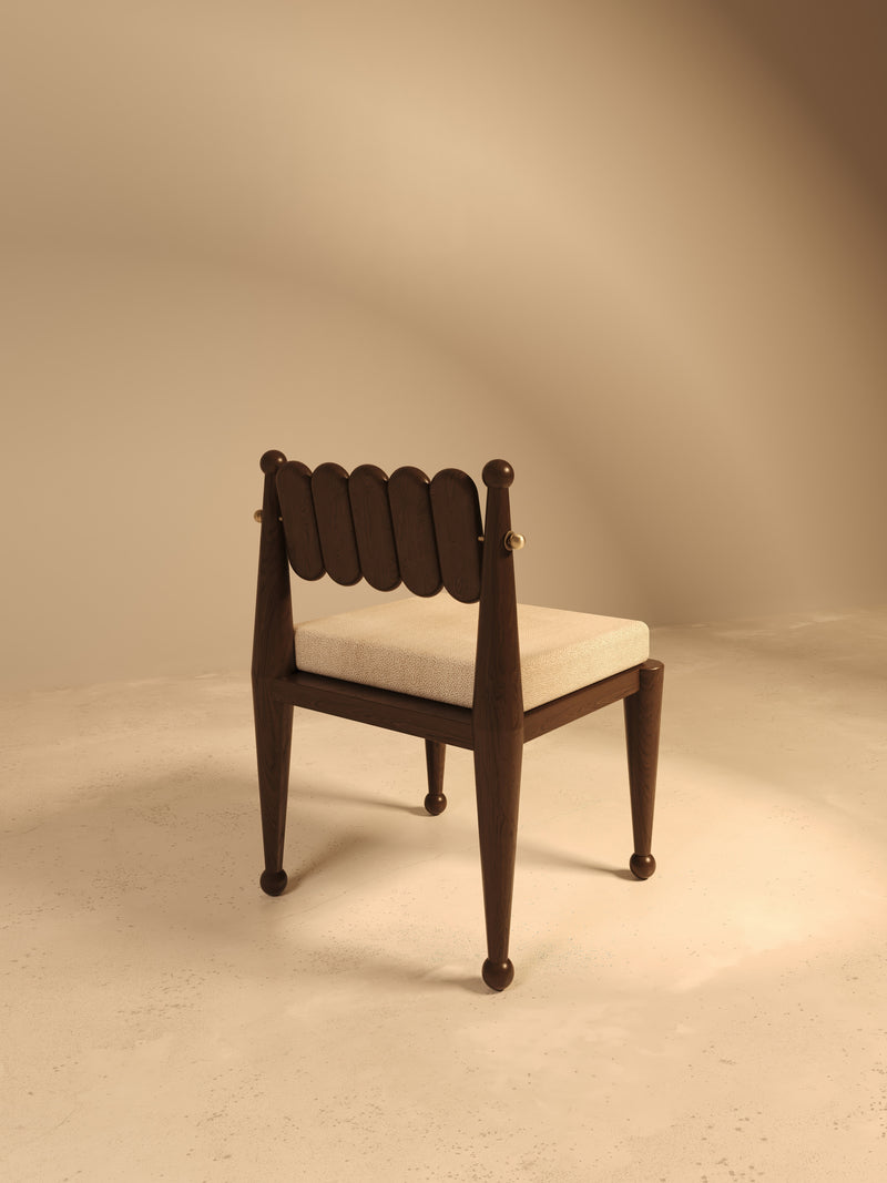 Modern walnut chair with scalloped back and cream upholstered seat