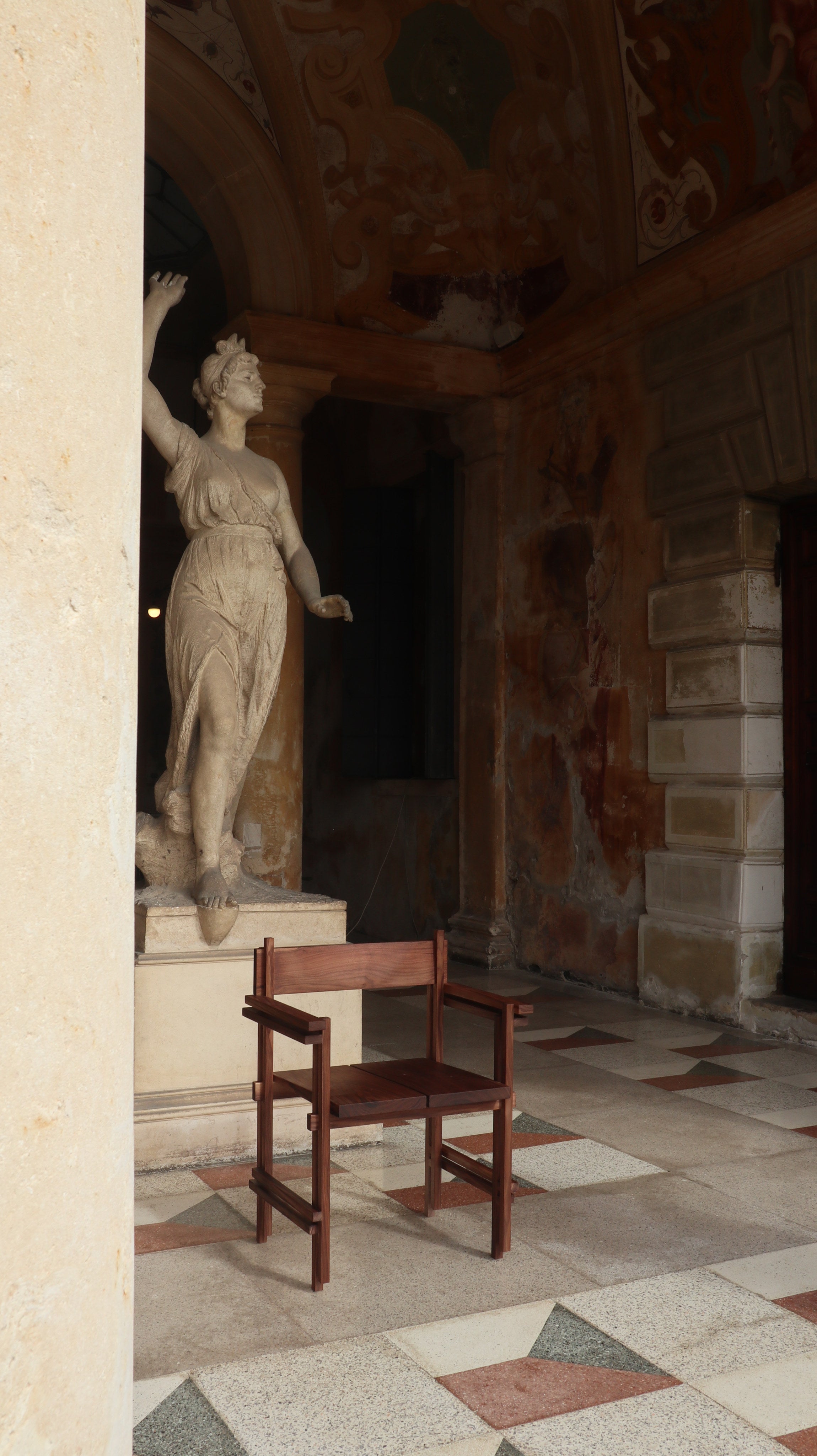 Stack chair with armrests — wooden chair in historic interior setting
