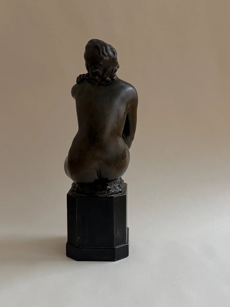 Bronze Sculpture of a Seated Woman — back view highlighting smooth surface and base