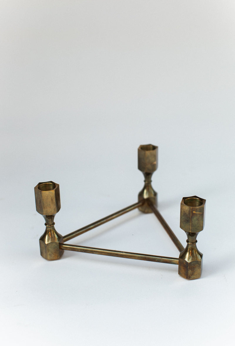 Modern brass triangular candelabra with three hexagonal holders
