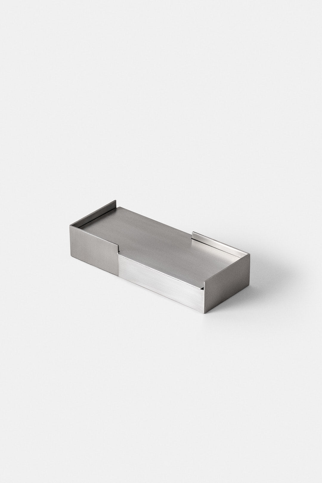 The HYZ Carlo - Medium desk set is a rectangular, minimalist office organizer made from handcrafted brushed steel, with low sides and an open slot at one end, shown on a plain white background.