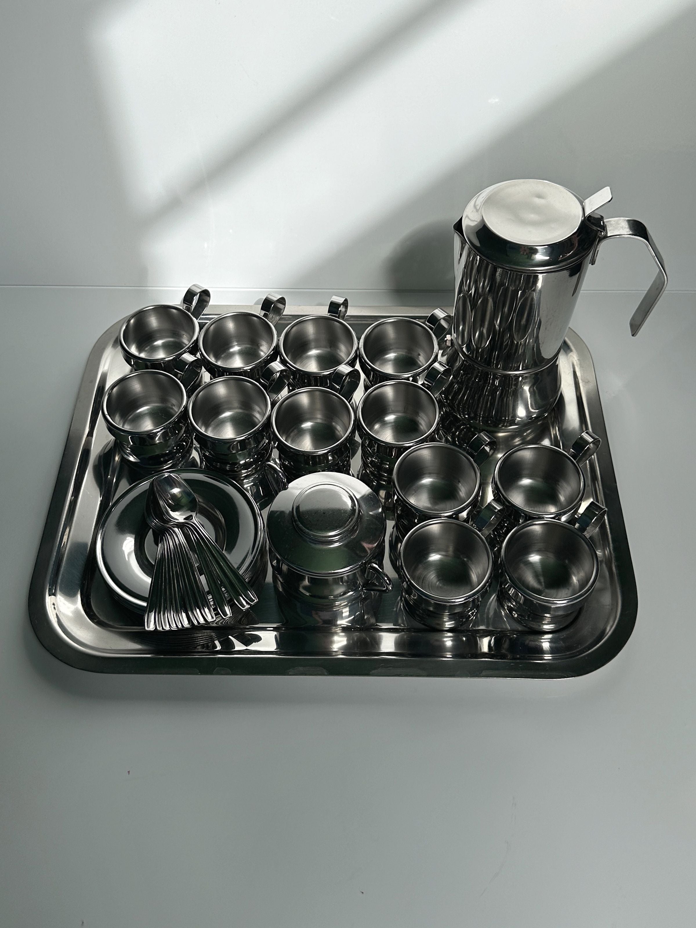 Italian Stainless Steel Coffee Set for 12 Persons — side angle on reflective tray