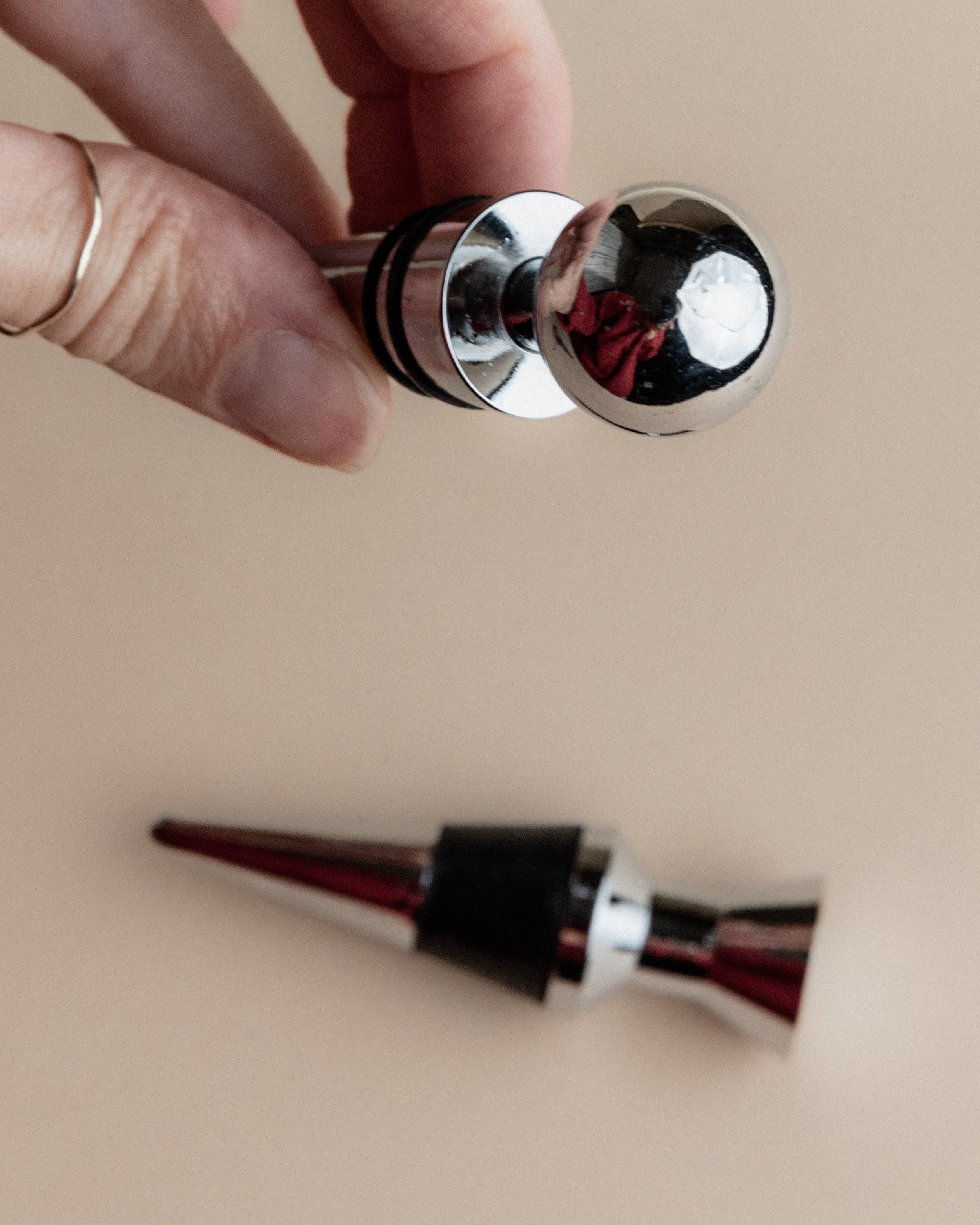 Vintage 1980s Bottle Stoppers Set of 2, Metal Geometric Conical Design Italy — close-up of shiny chrome finish and conical sh