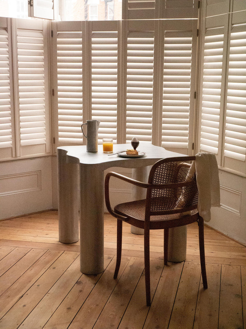 Aluminum Dining Table — corner view in bright room with wooden floor