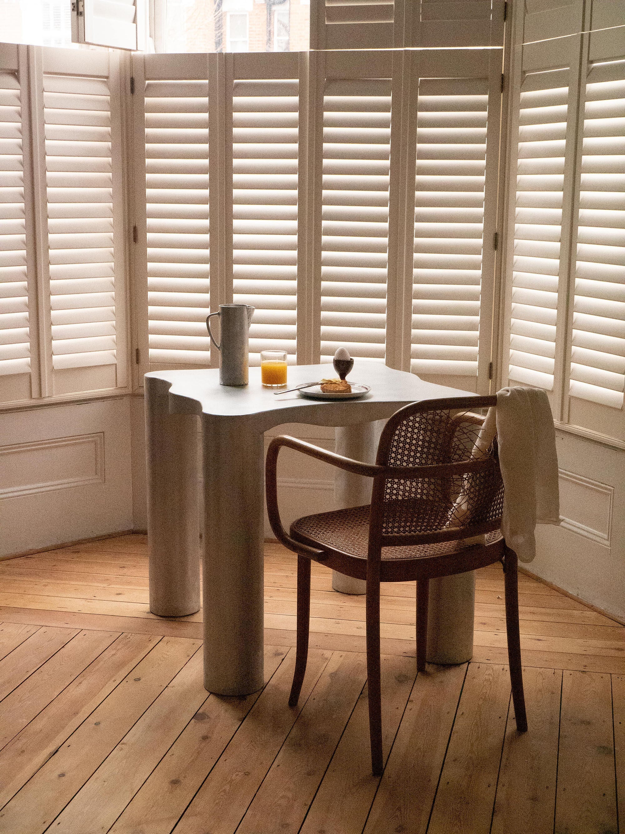 Aluminum Dining Table — corner view in bright room with wooden floor