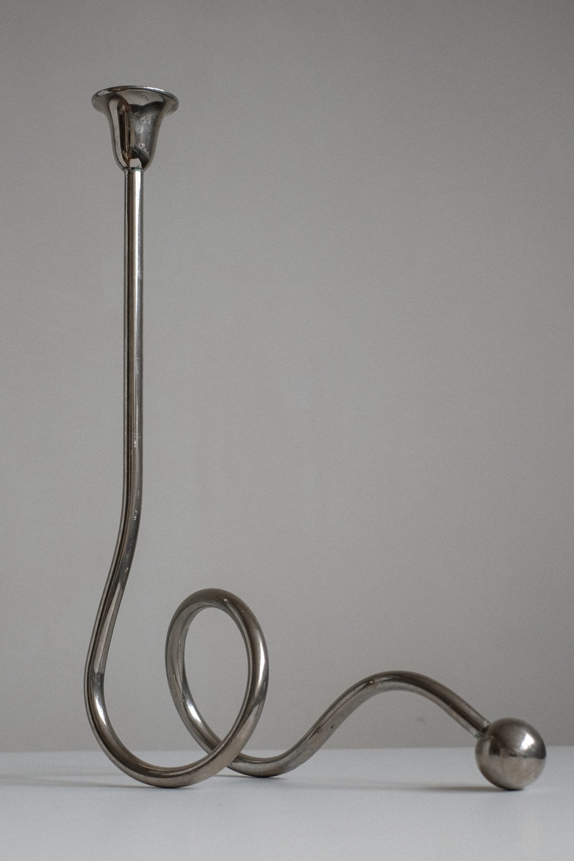 Chrome Candle Holder by Guido Niest — back view of curved chrome design