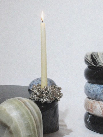 Chrome Candle Holder — positioned on a marble surface with candle
