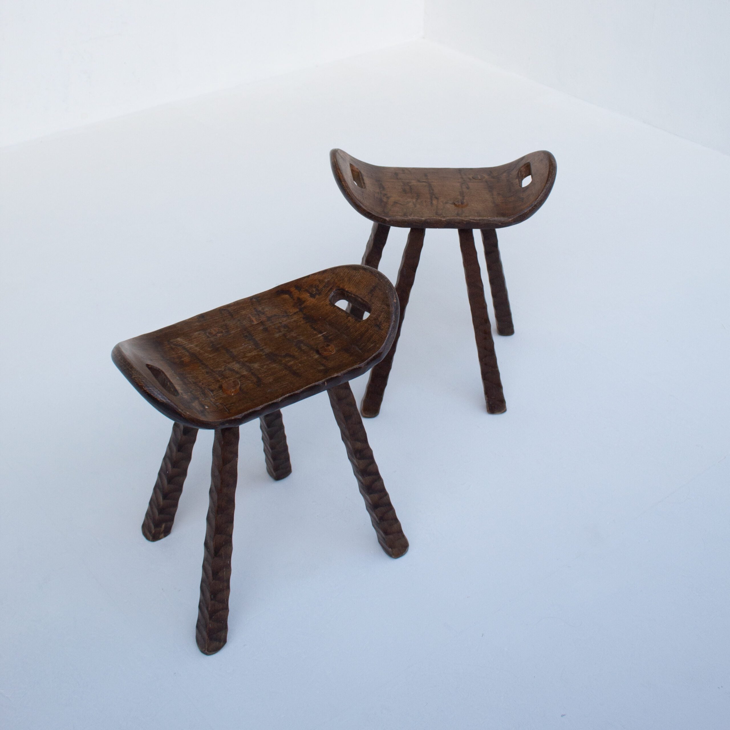 Set of Brutalist stools — side angle showing carved wooden seats