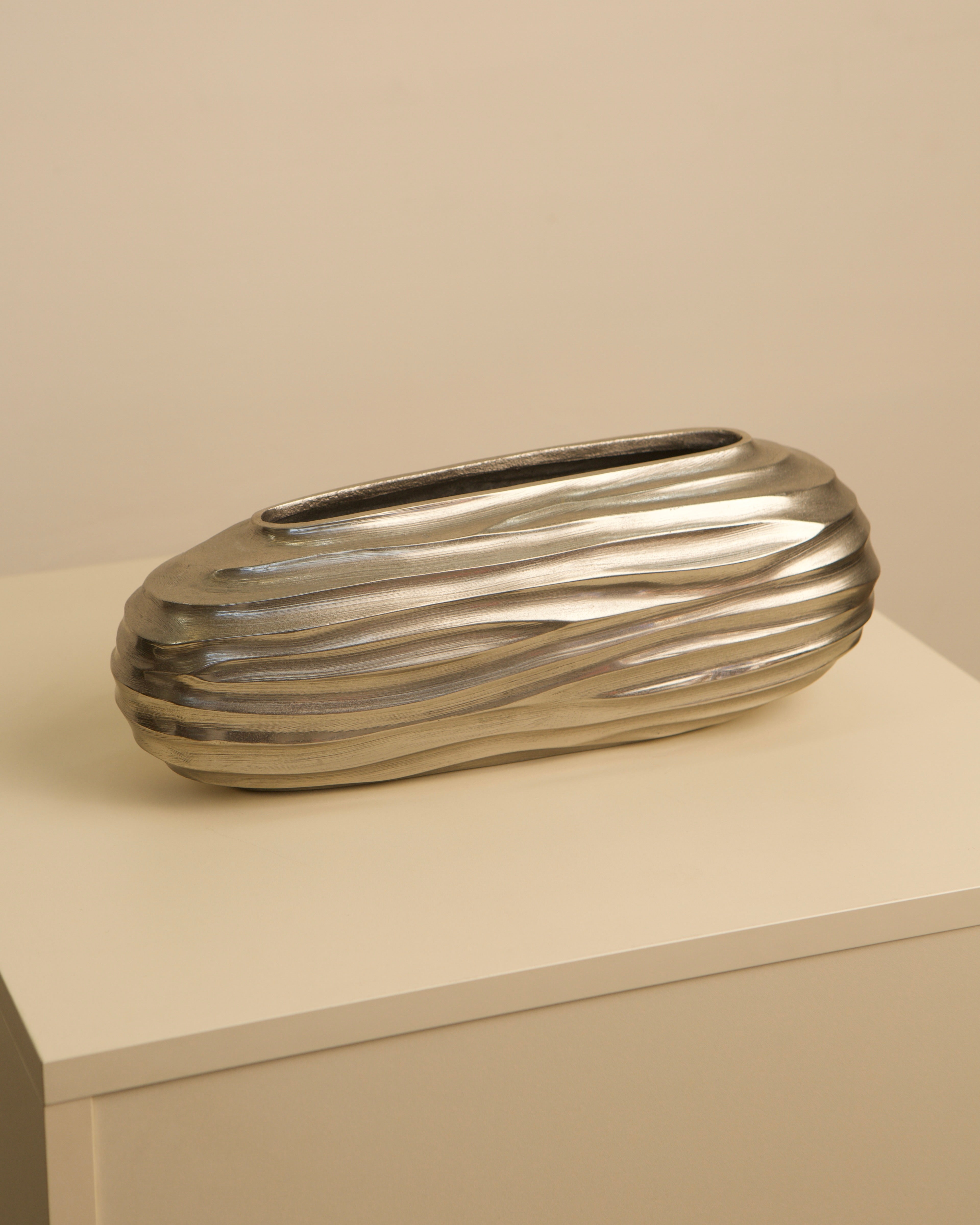 Ribbed aluminum vase profile showing horizontal grooved texture