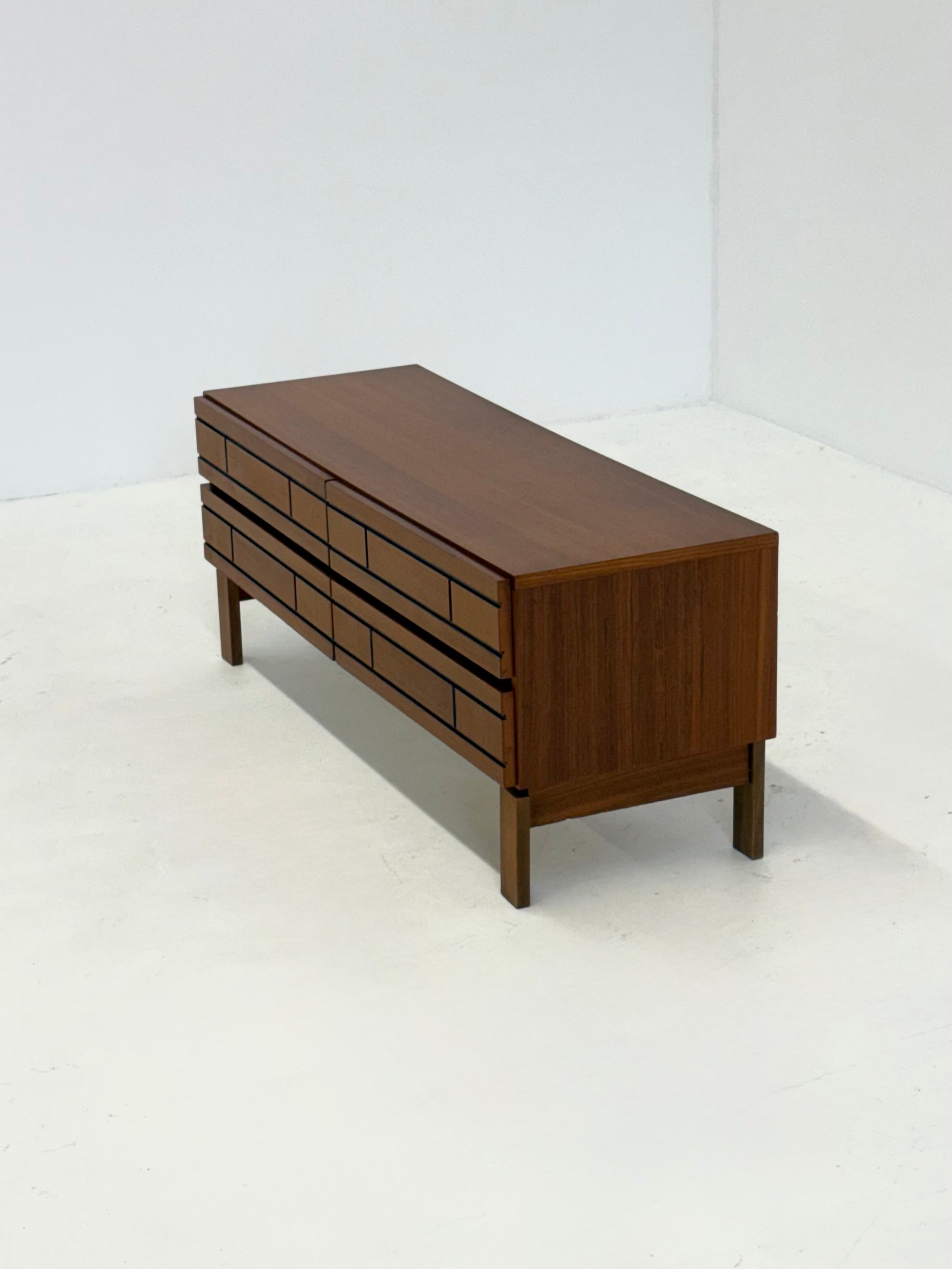 Low Italian wooden sideboard with graphic black lines — lifestyle setting