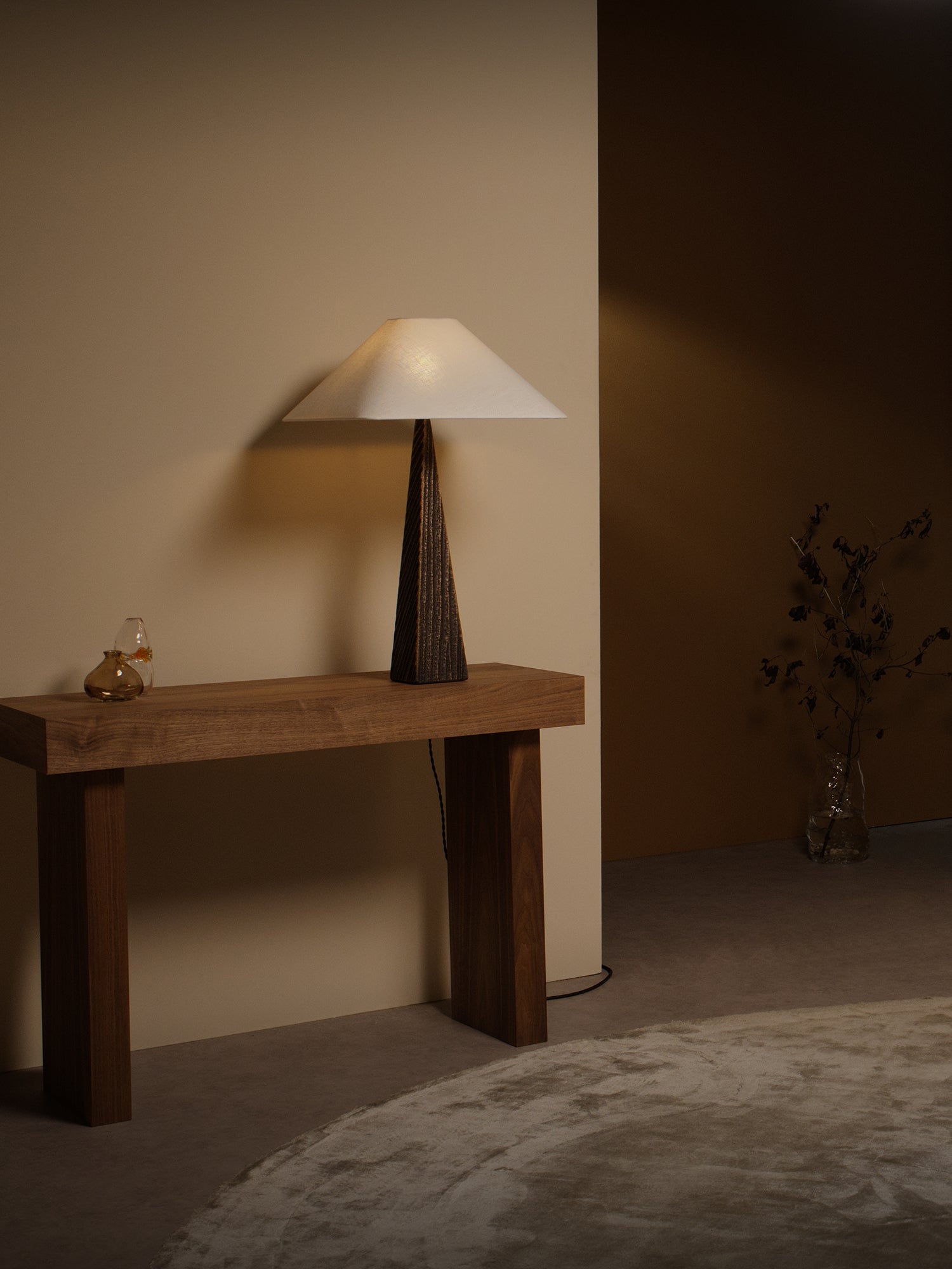 CUBIST Table — side angle on wooden console in warm setting