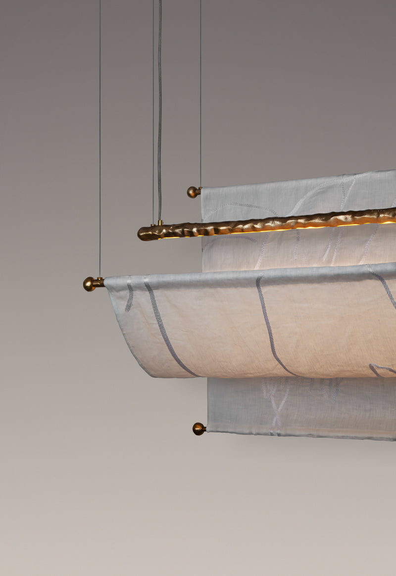 Aria Ceiling — close-up of linen shade with brass accents