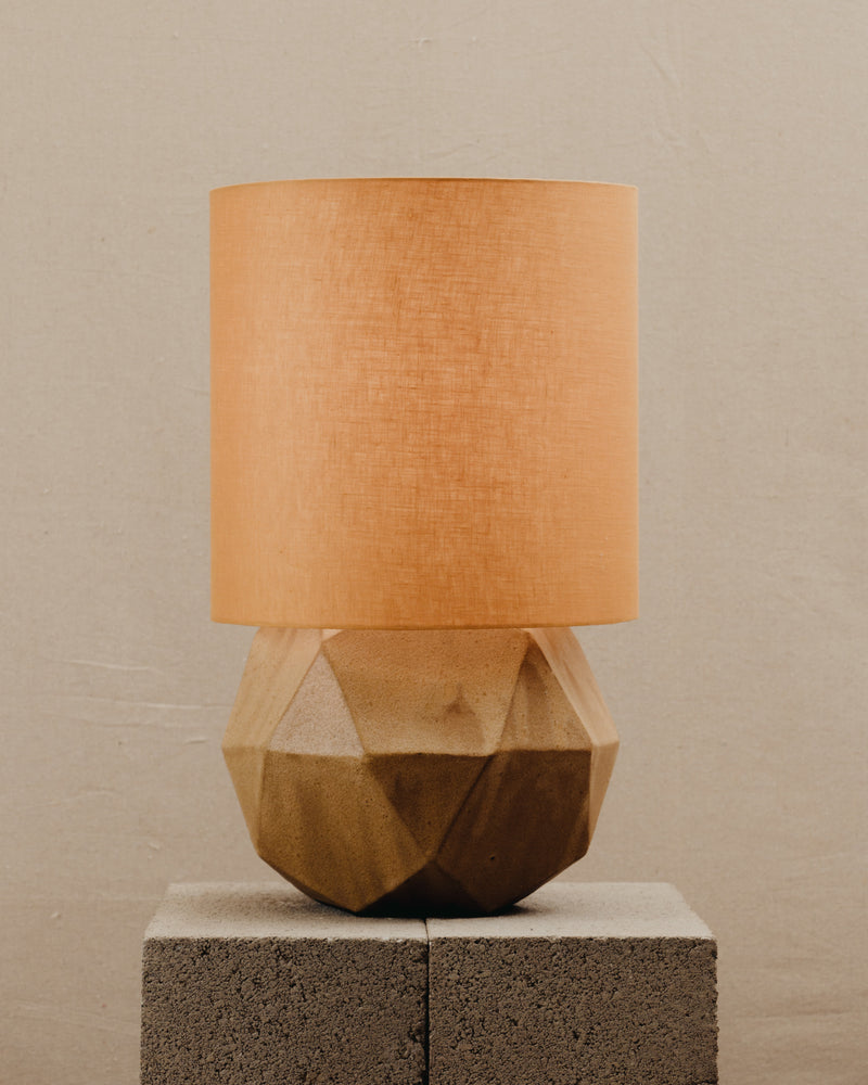 Geode Lamp — close-up of geometric stone base with orange shade