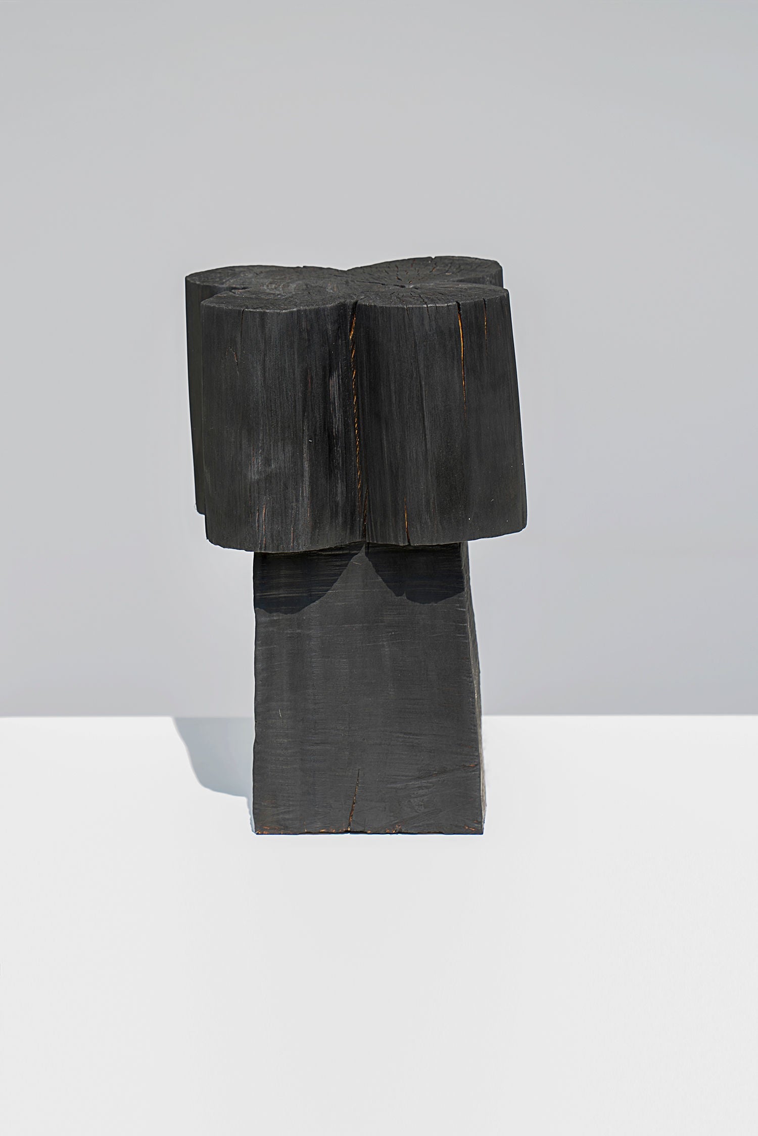 Burnt Black Coffee Tables/Stools — close-up of textured black wood surface