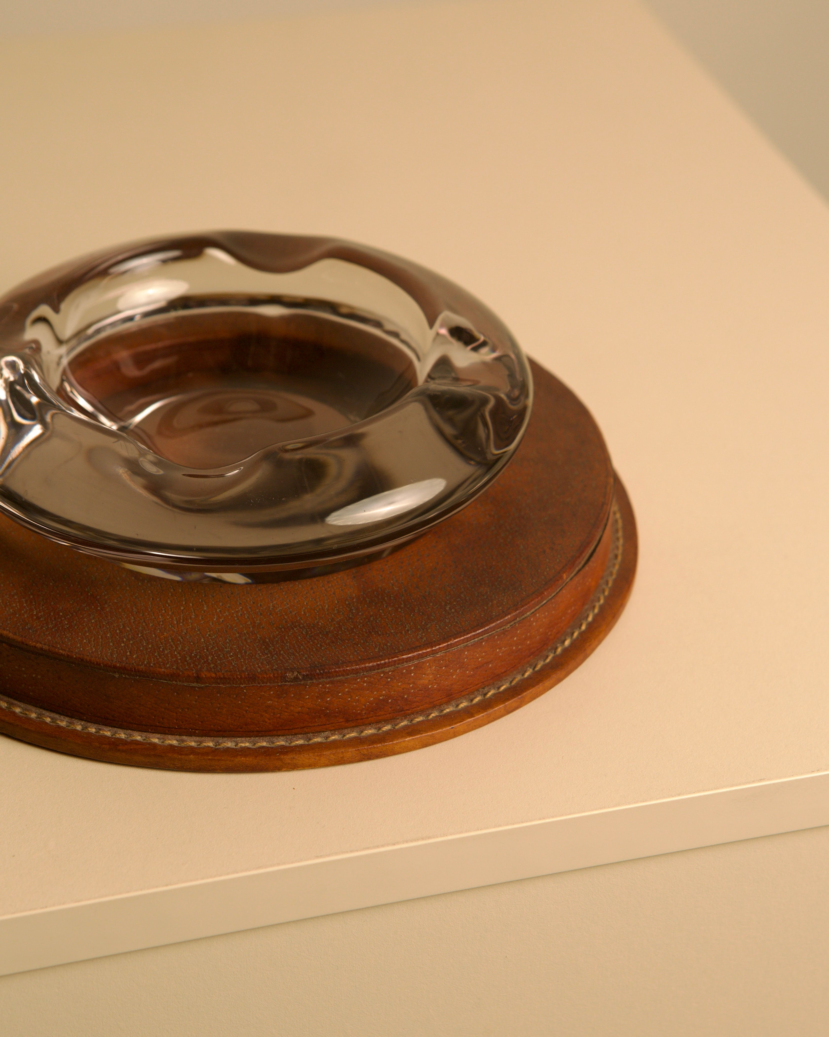 Italian ashtray in patinated brown leather and crystal, 1950s — side angle showing leather base and glass bowl