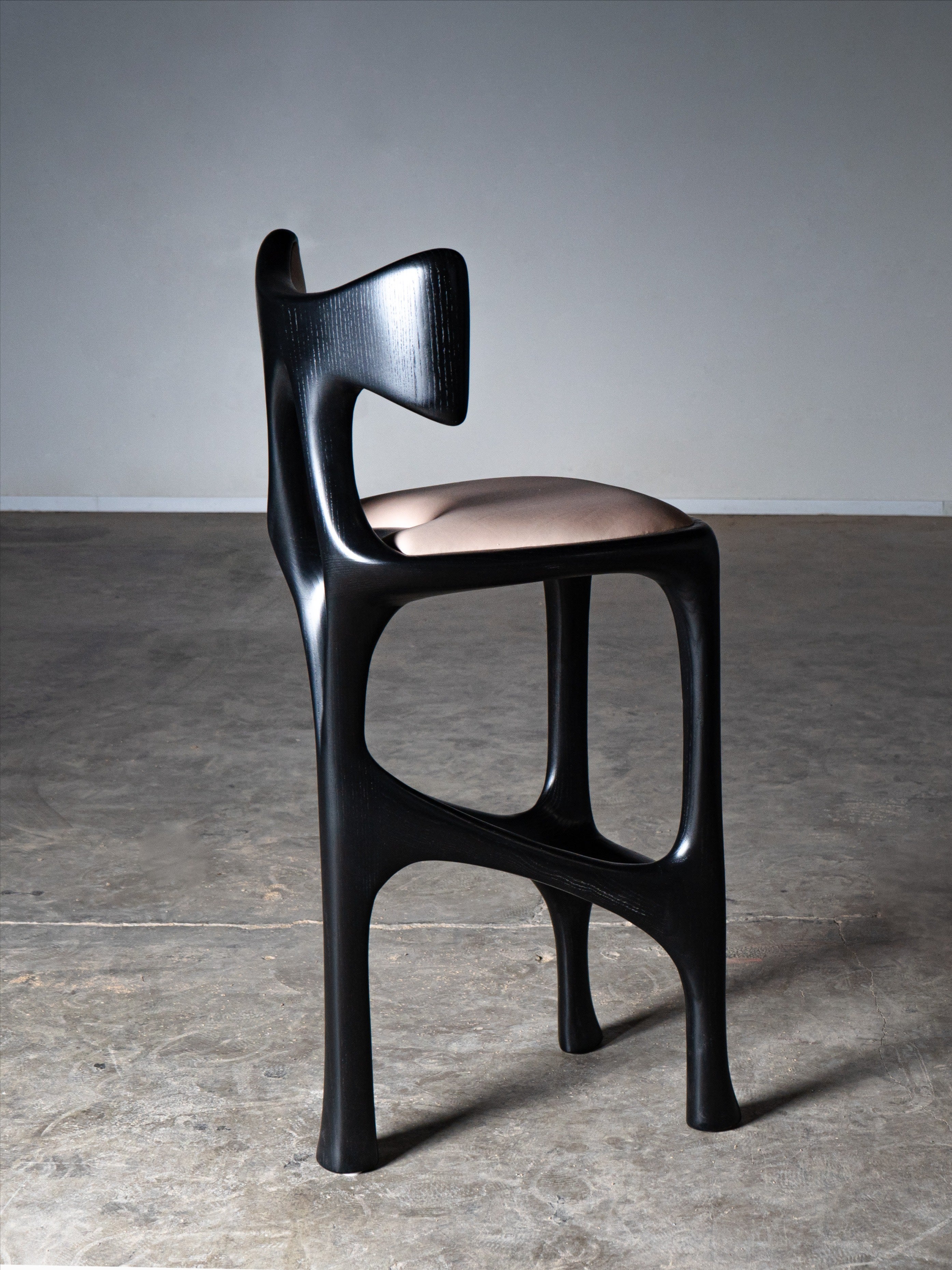 Tripa Stool in Ebony stain on Ash Wood — side view highlighting curved backrest