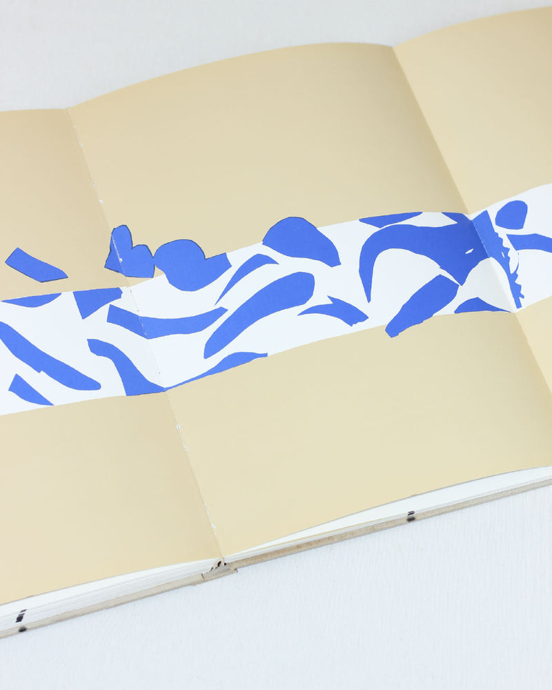 Matisse Paper Cutouts — close-up of blue paper cutouts on beige background