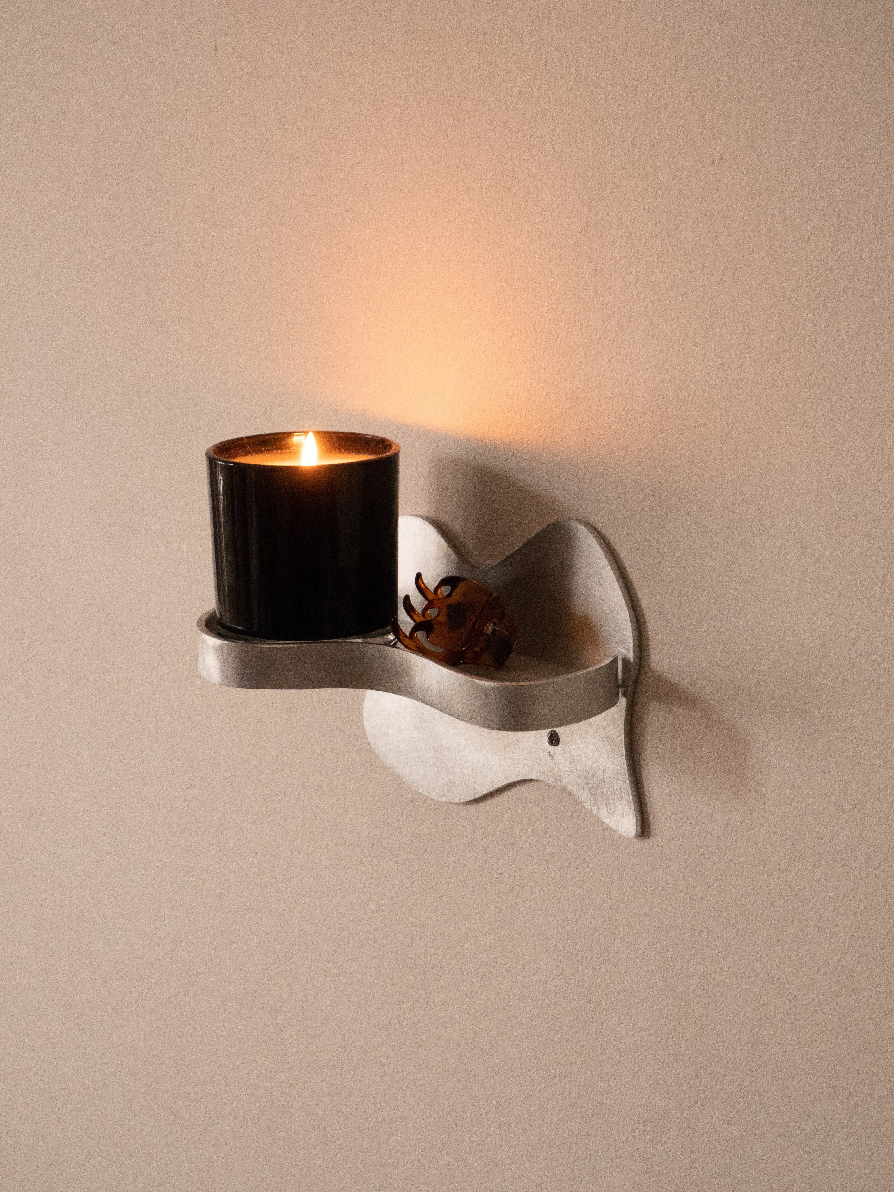 Small Shelf — close-up of silver metal design with candle
