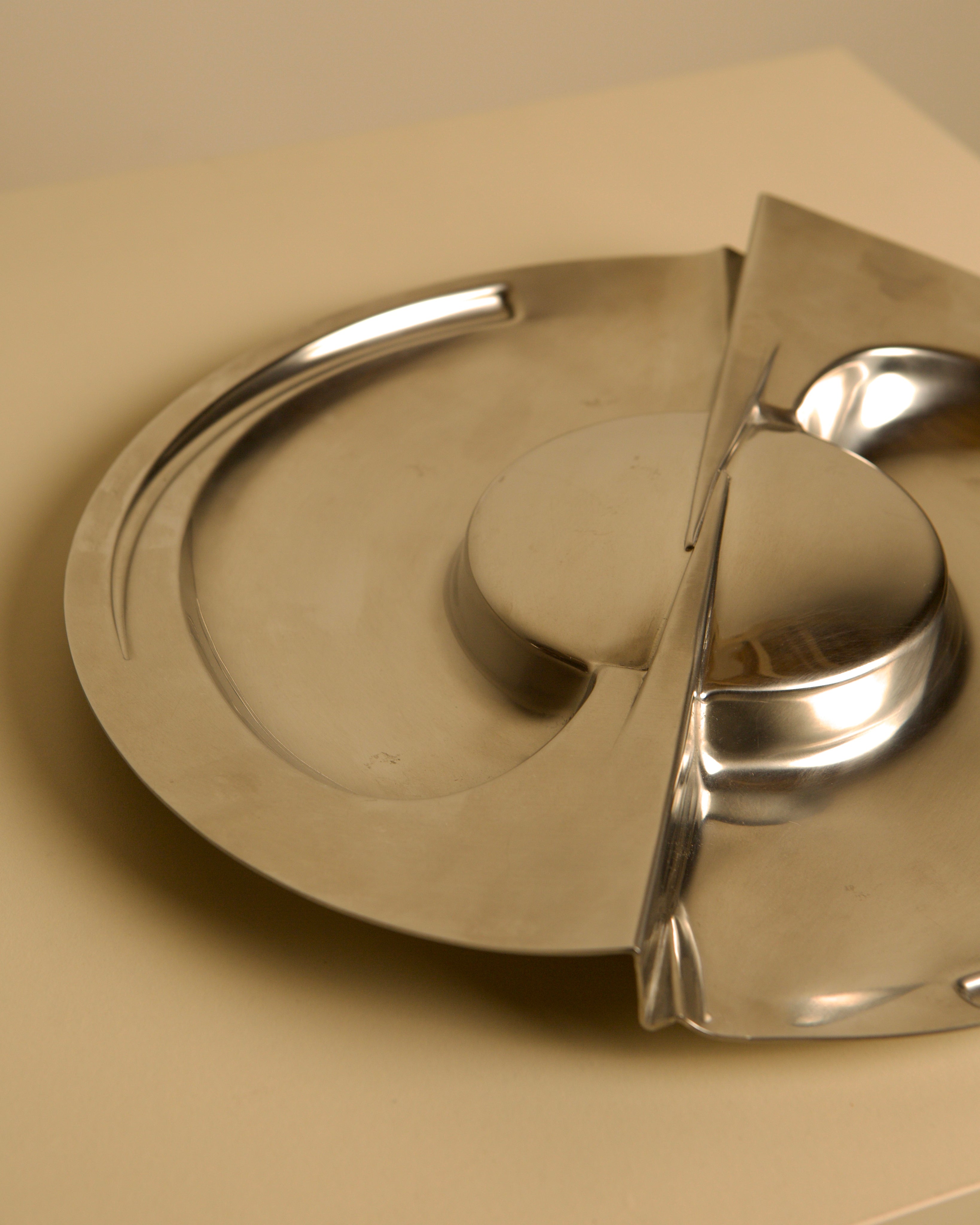 Large metal storage compartment 'Forma Orizzontale Circolare' by Carmelo Cappello for Ales — close-up of polished stainless s