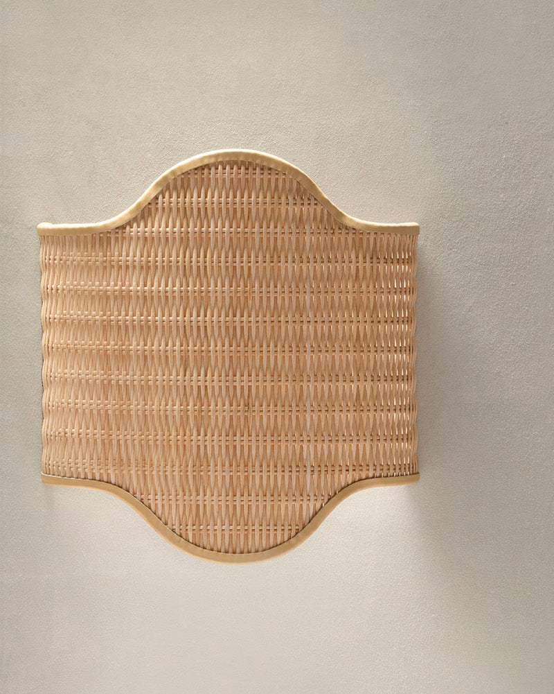 Woven rattan wall light with curved wooden frame detail