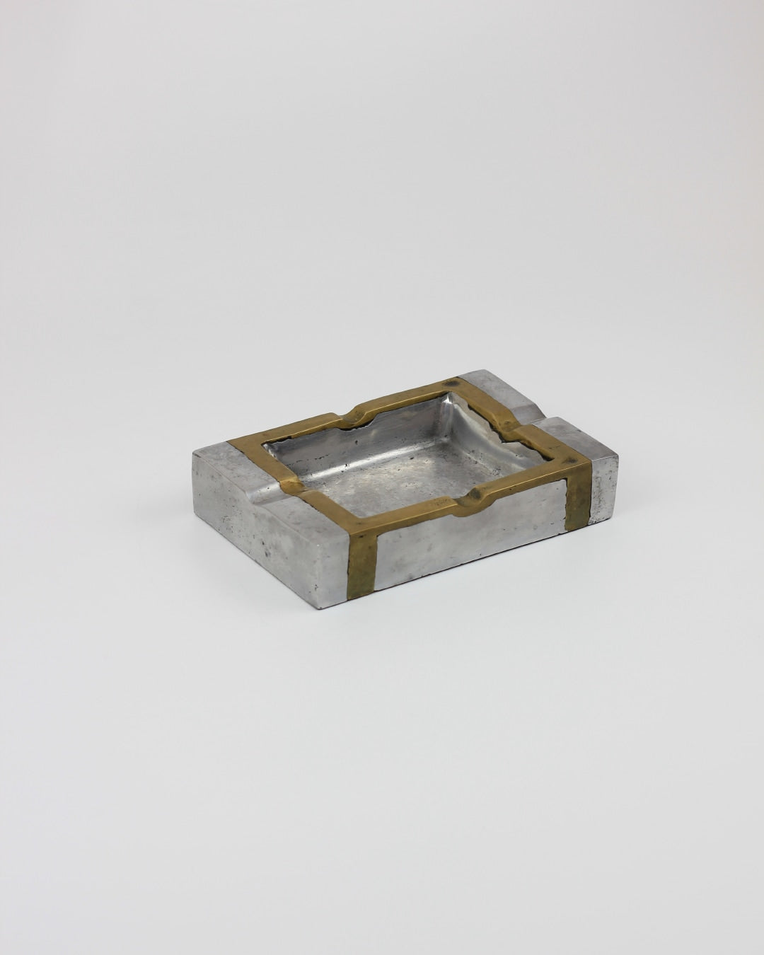 Brutalist Ashtray — angled view highlighting metal and brass details