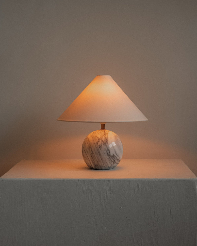 Marble Table Lamp — close-up of round marble base with warm light