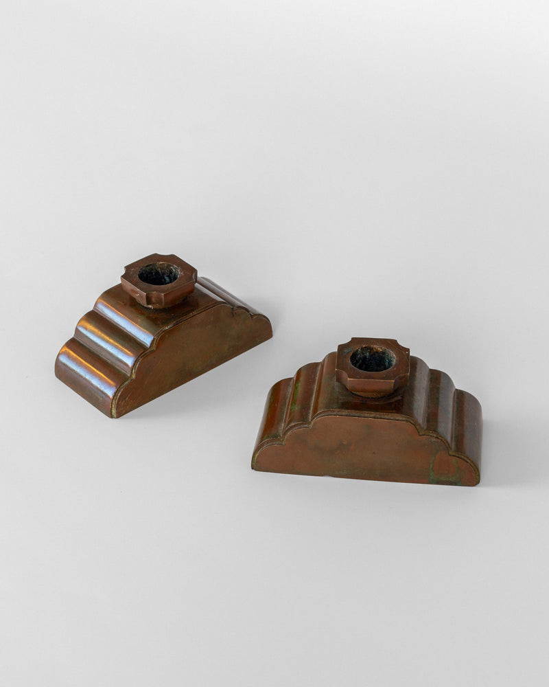 Two bronze candleholders by Sune Bäckström showing stepped design