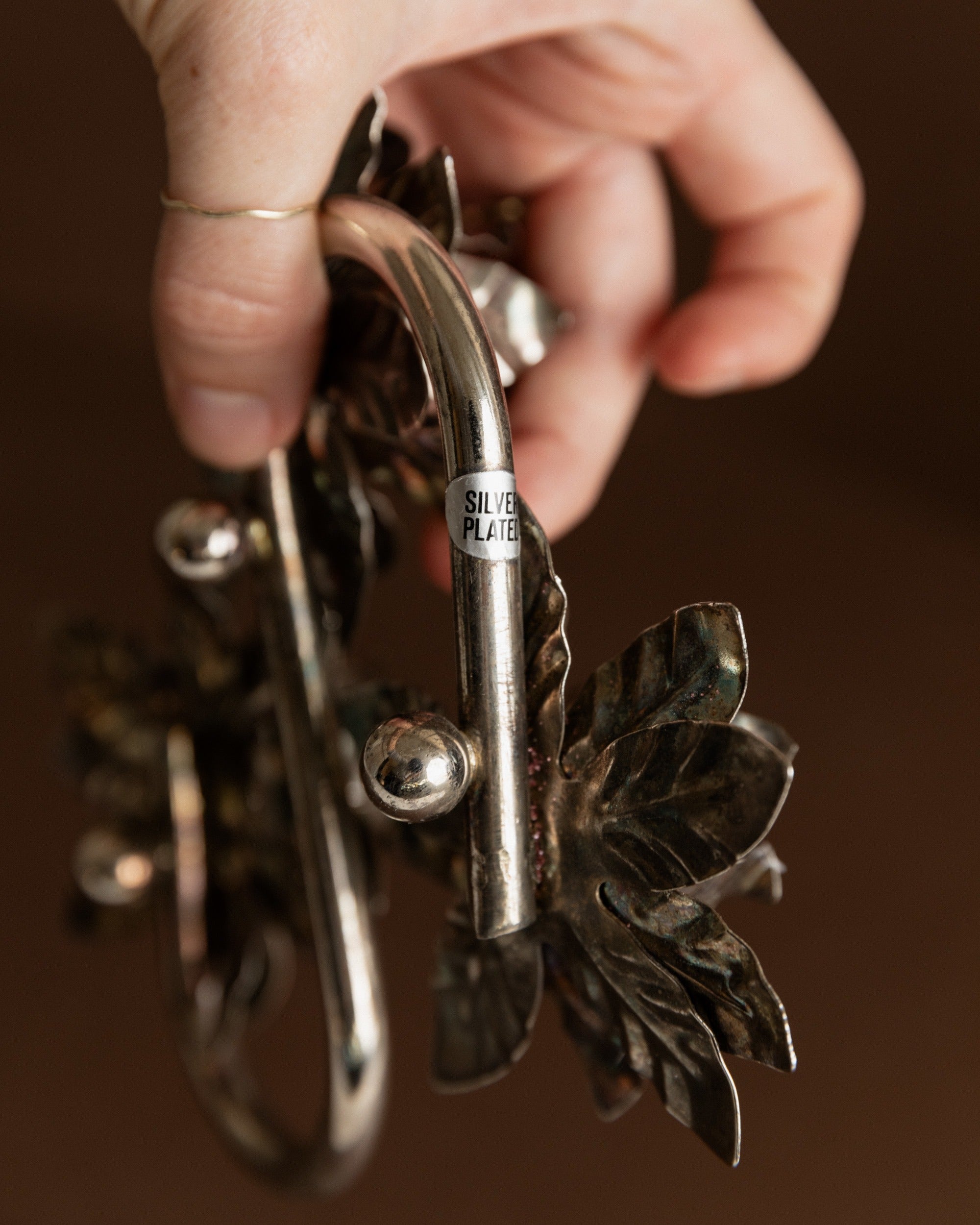 Silver Plated Vintage Candleholders — hand-held view highlighting floral design