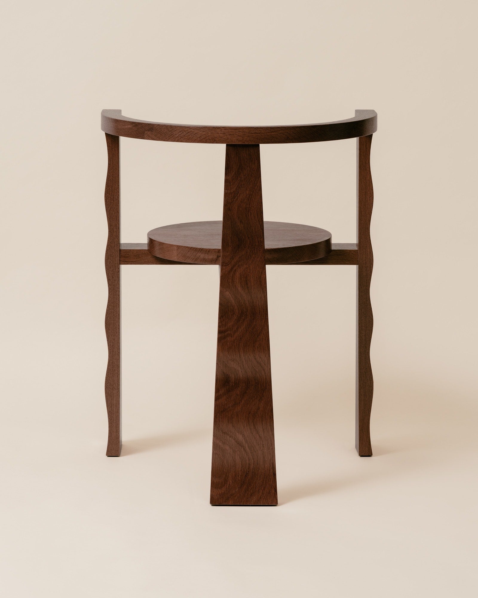 Puro walnut chair profile view showing curved legs and circular shelf