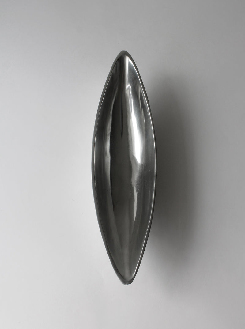 Polished aluminum elongated bowl with sleek reflective surface