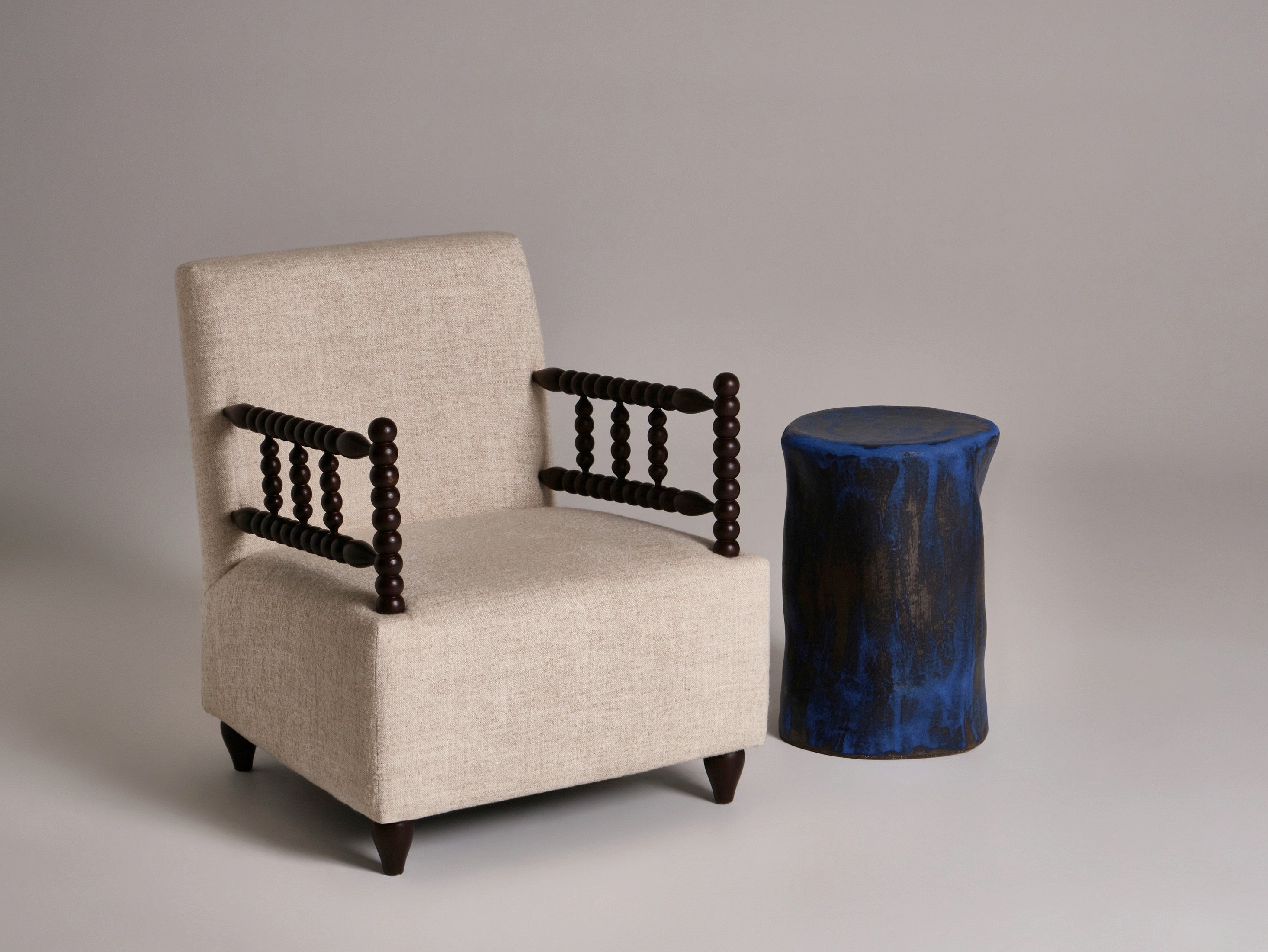 Small Ceramic Side Table — top view with blue finish beside beige chair