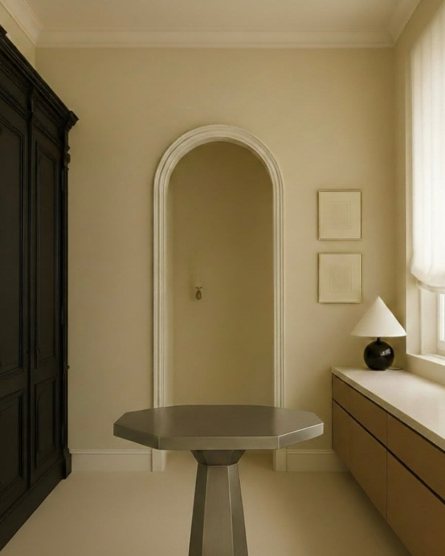 Hexagonal stainless steel Table — angled view in minimalist room