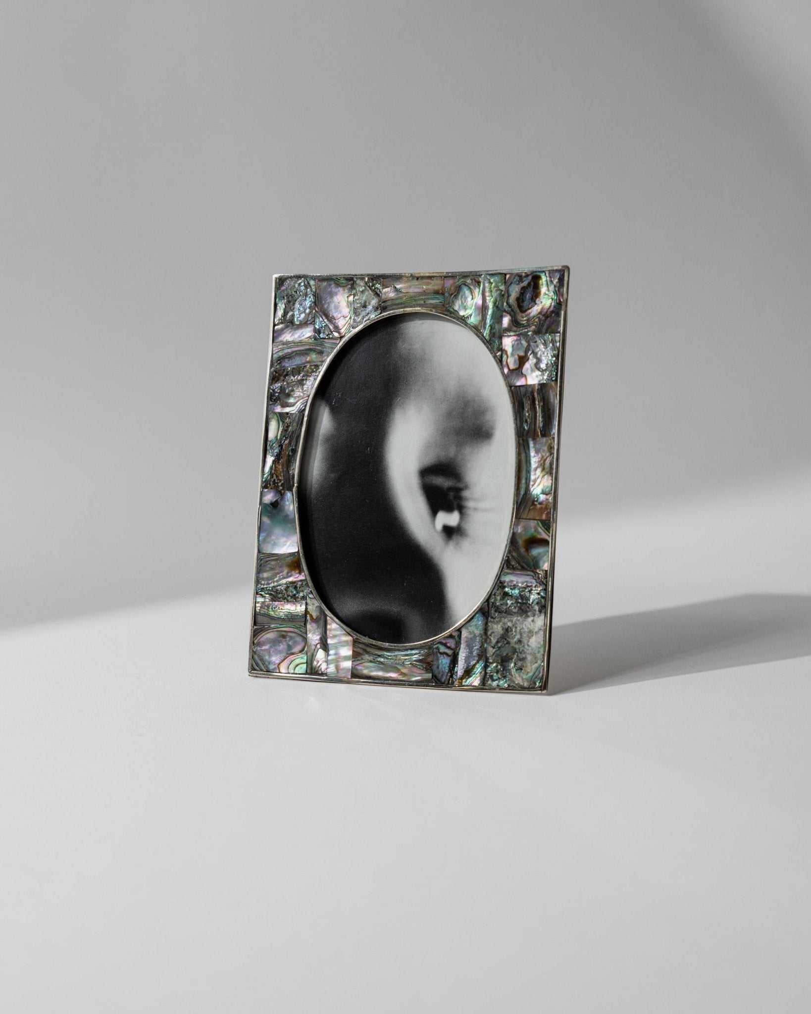 Vintage 1950s Alpaca Silver Picture Frame, Mother of Pearl Details with Oval Photo Opening, Elegant Table Accent, Timeless Gift Idea — in context