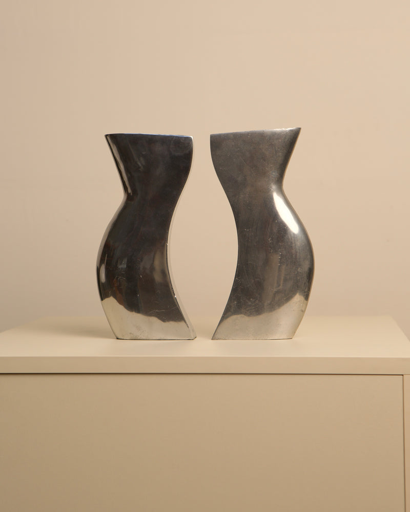 Pair of Italian cast aluminum Dance vases with curved silhouettes
