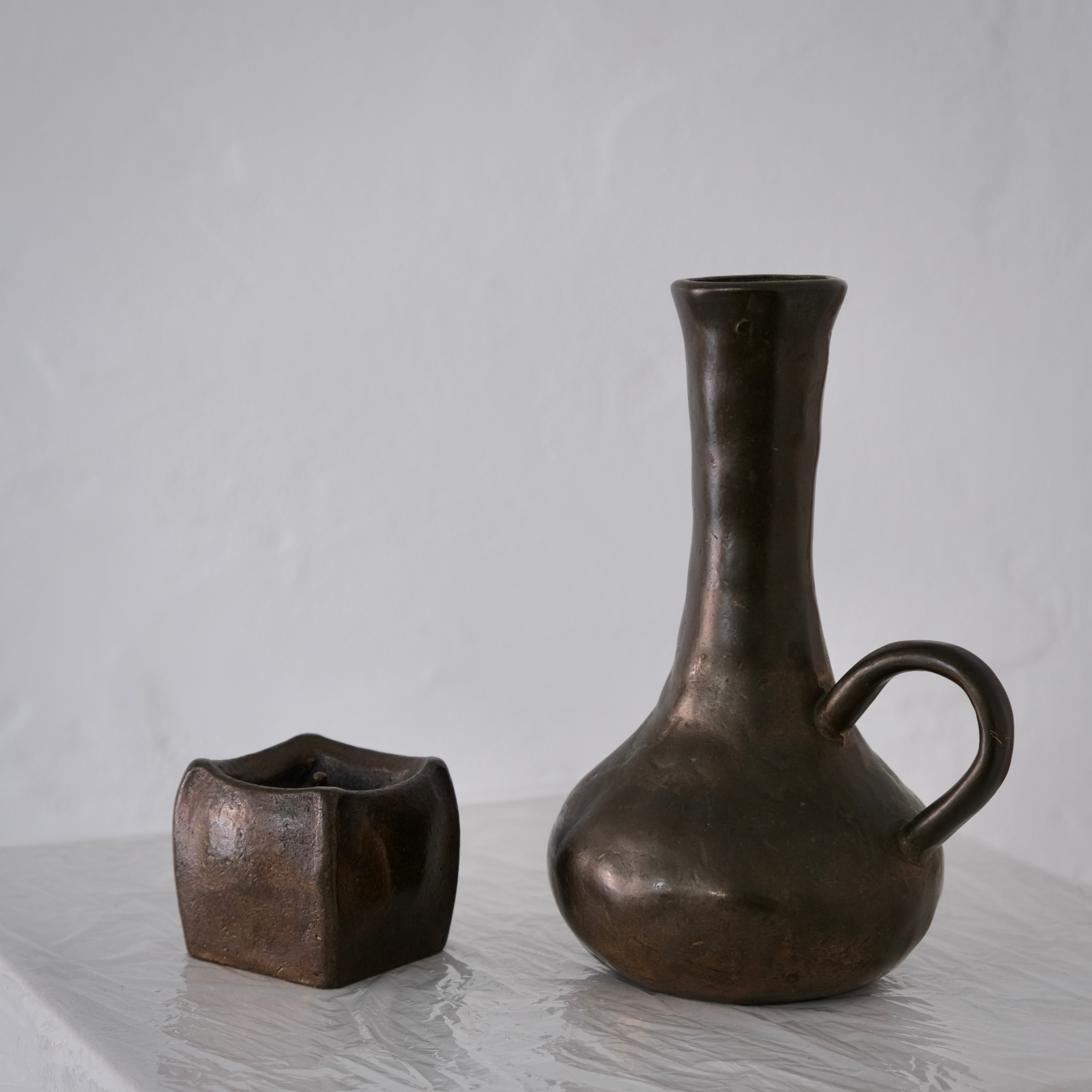 Brutalist Cast Bronze Candle Holder & Vase Set, 1970s — side angle on white surface