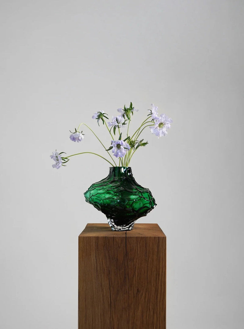 Canyon Vase - Large - Green — close-up of textured green glass with flowers