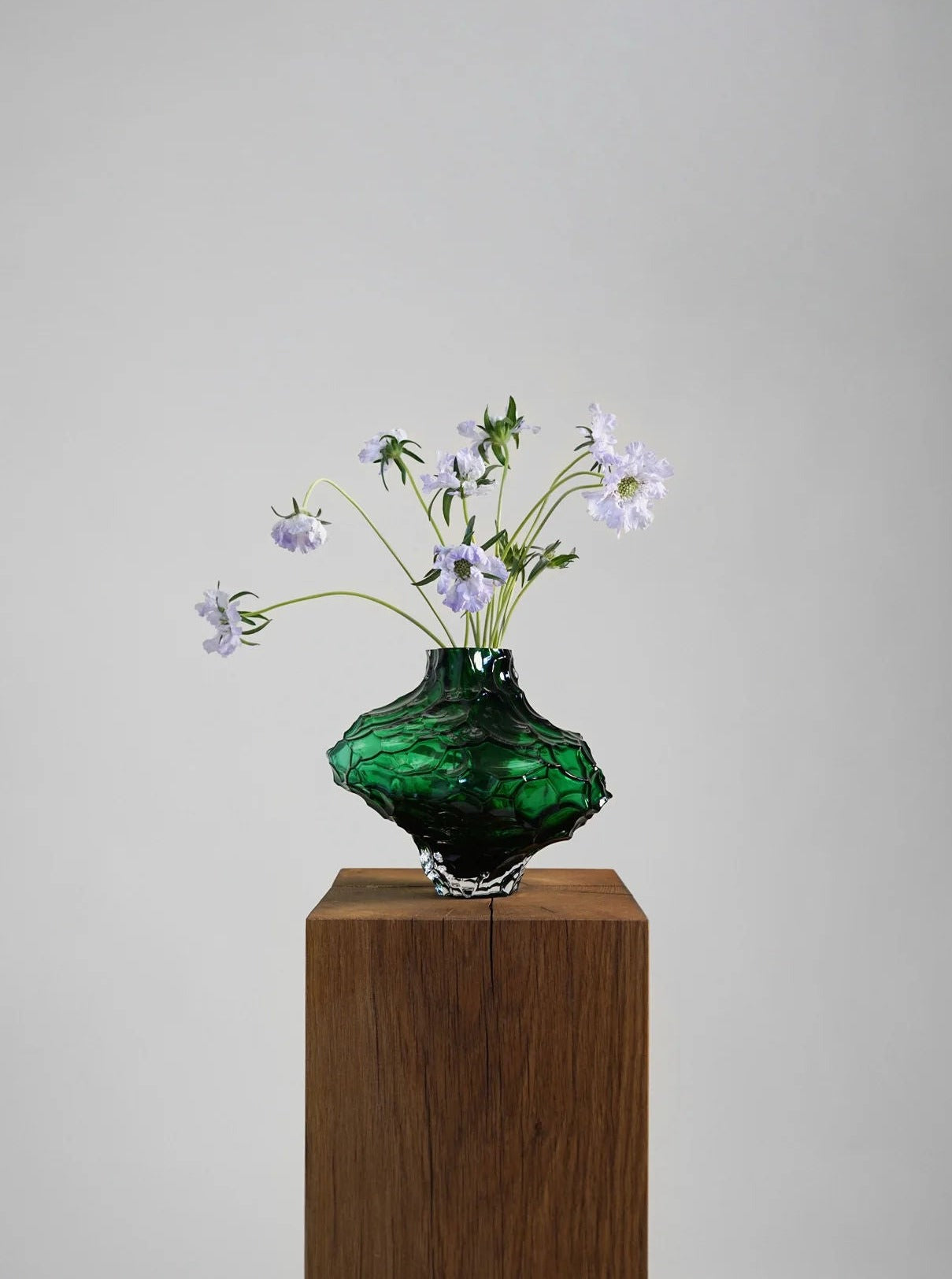 Canyon Vase - Large - Green — close-up of textured green glass with flowers