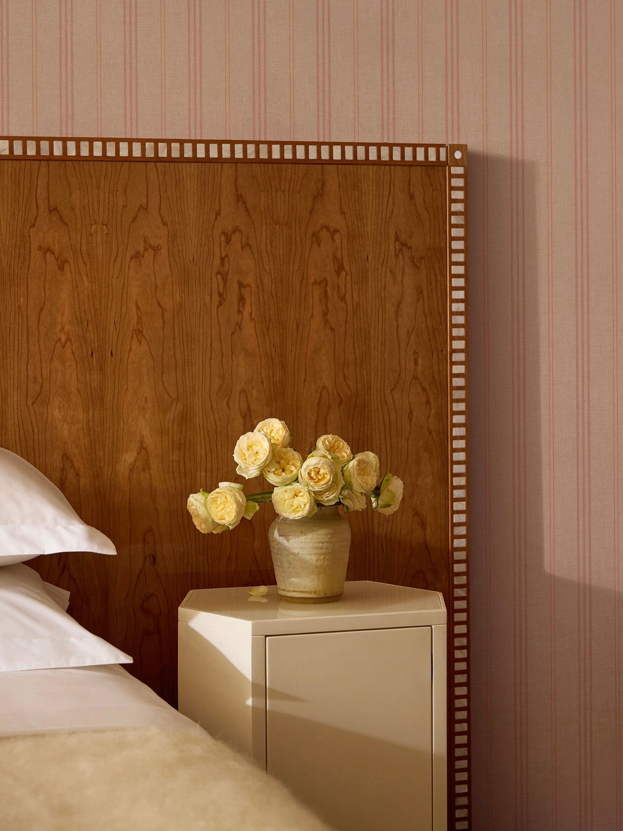 Aquarama Headboard in Cherry — side angle with floral vase on nightstand