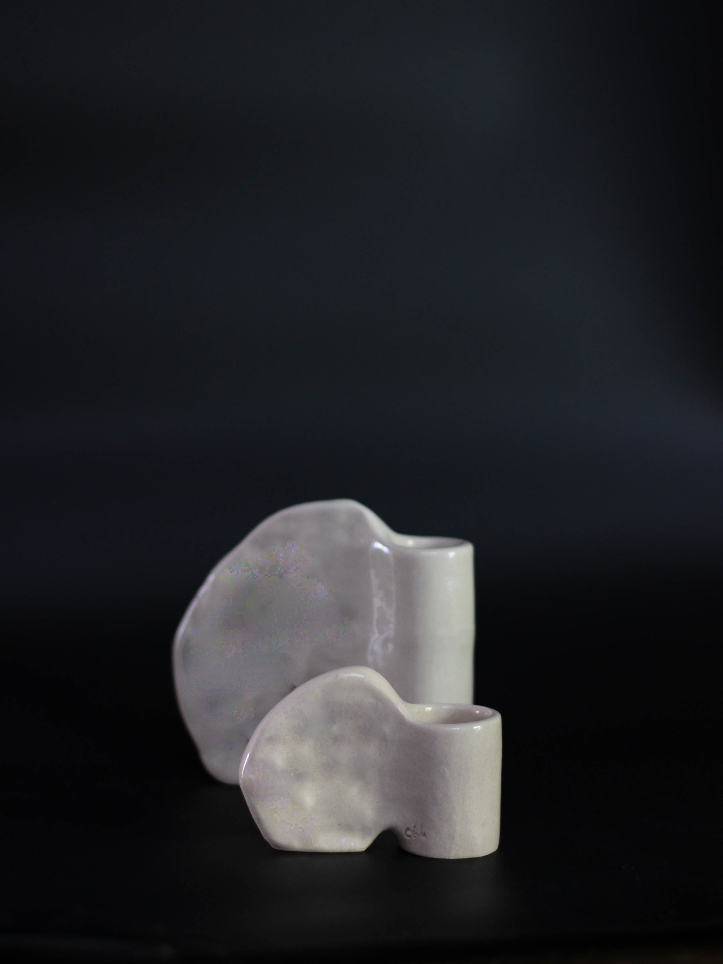 Candleholder in Stoneware with wing — angled view on dark background