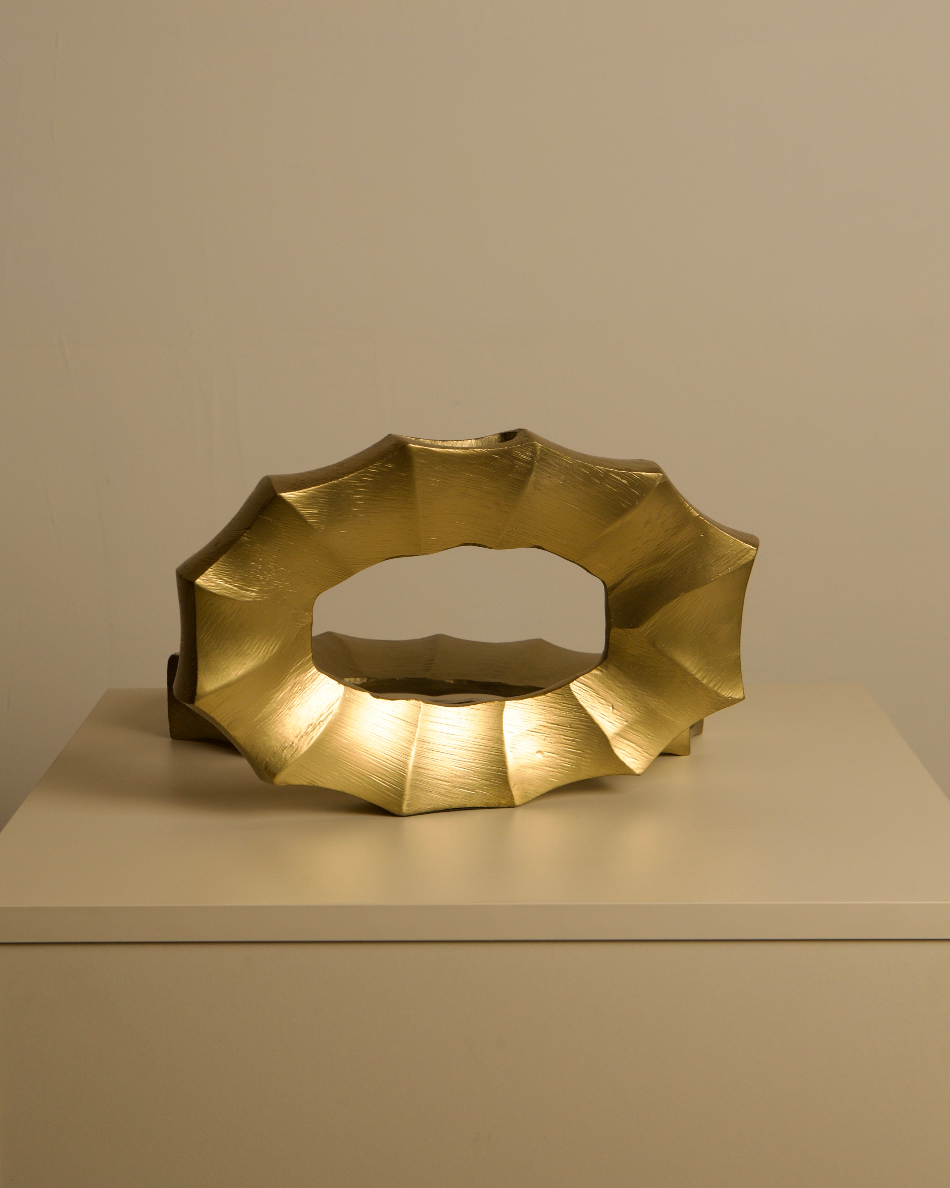 Pair of Italian 80s Gilt Aluminum Vases — angled view on neutral surface