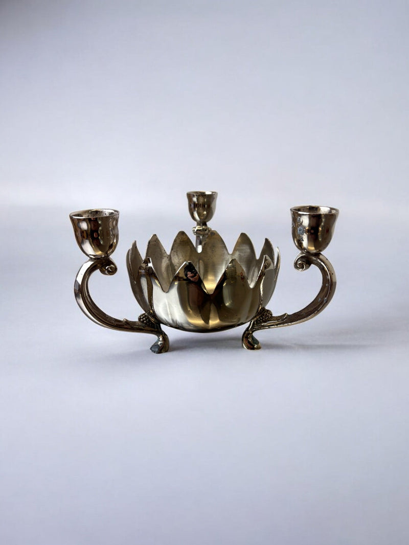 Art deco waterlily Candelholders, France, 1960's — close-up of polished metal with floral design