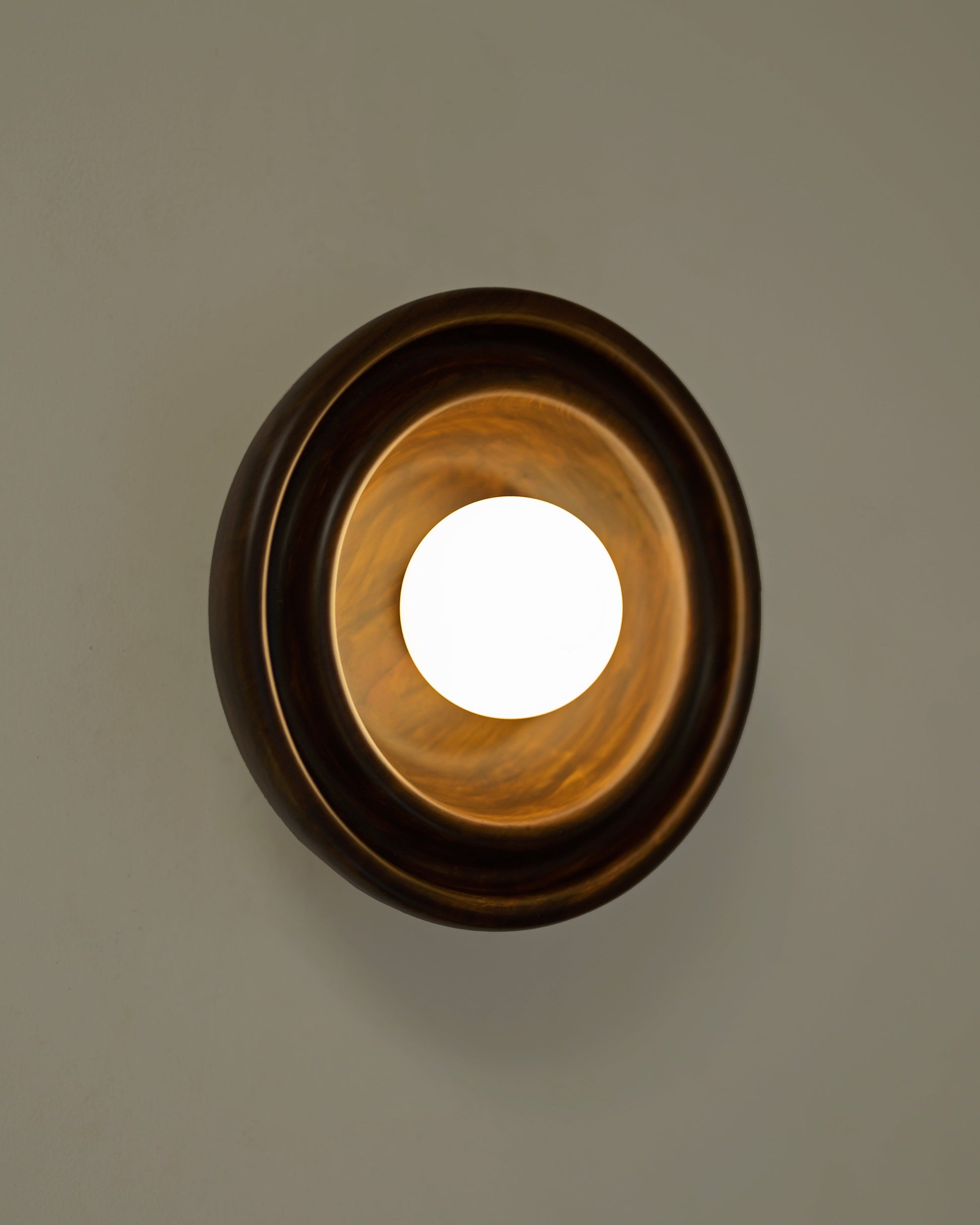 Discus XS Wall Light — top view of brass finish on wall