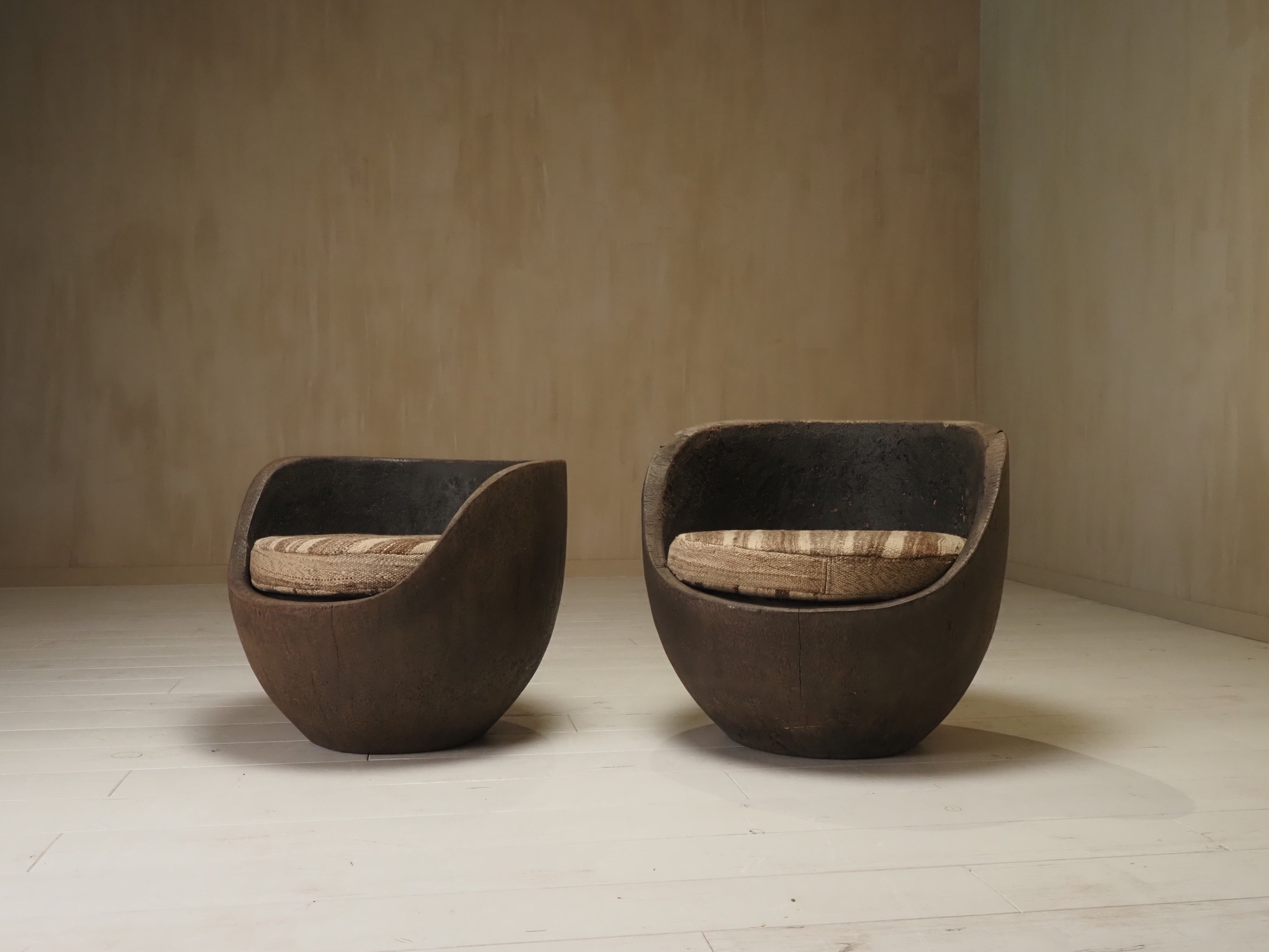 Sculptural mid-century hand-carved pair lounge chairs — lifestyle setting