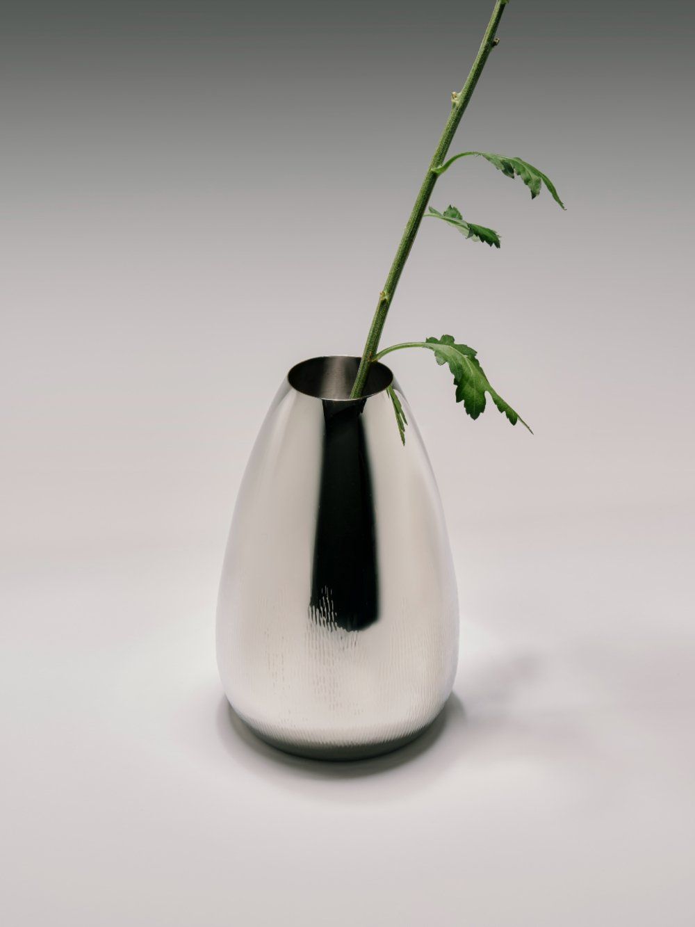 Modern Vase — side angle showing polished metal surface