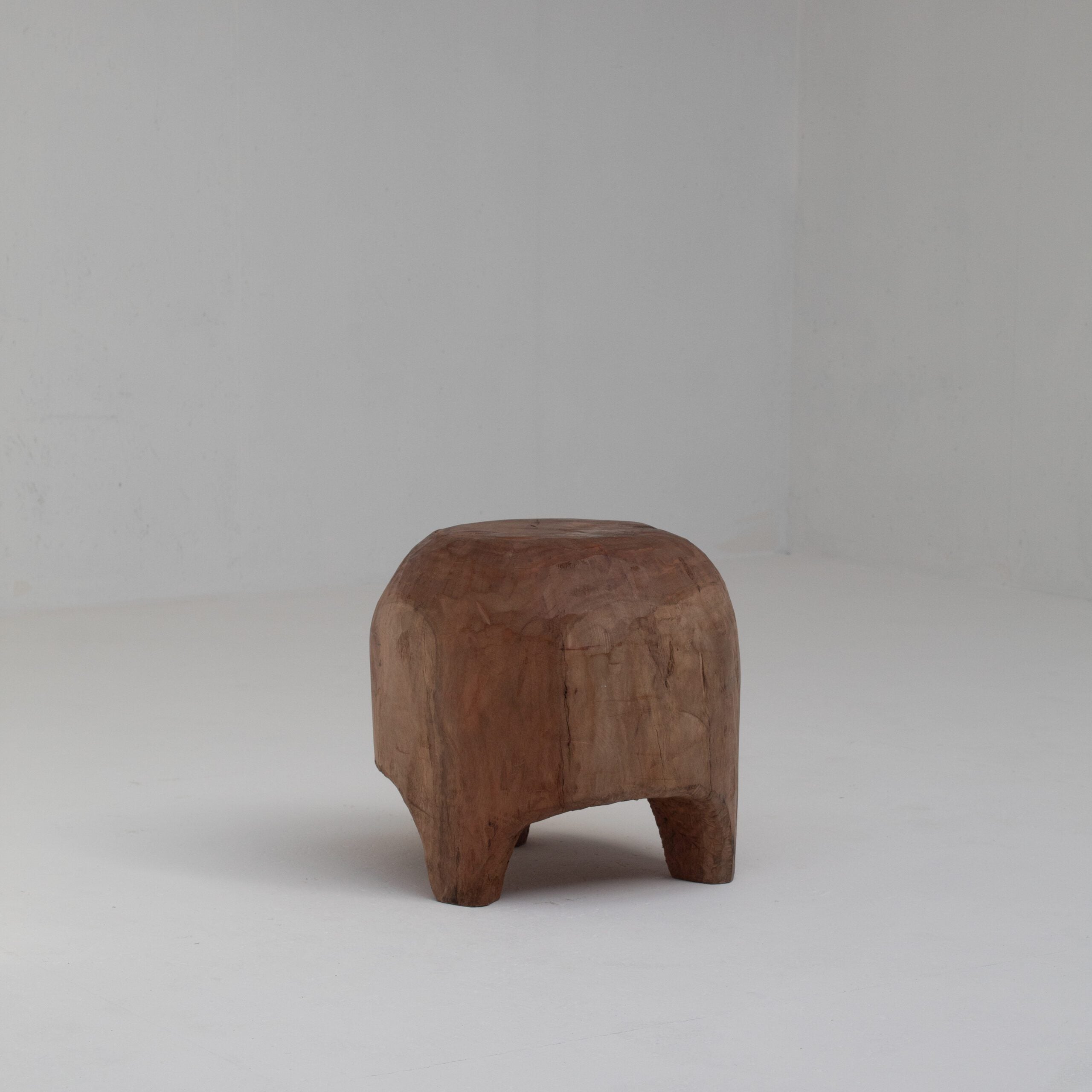 Sculptural Solid Wood Stool in Warm Natural Patina — in context
