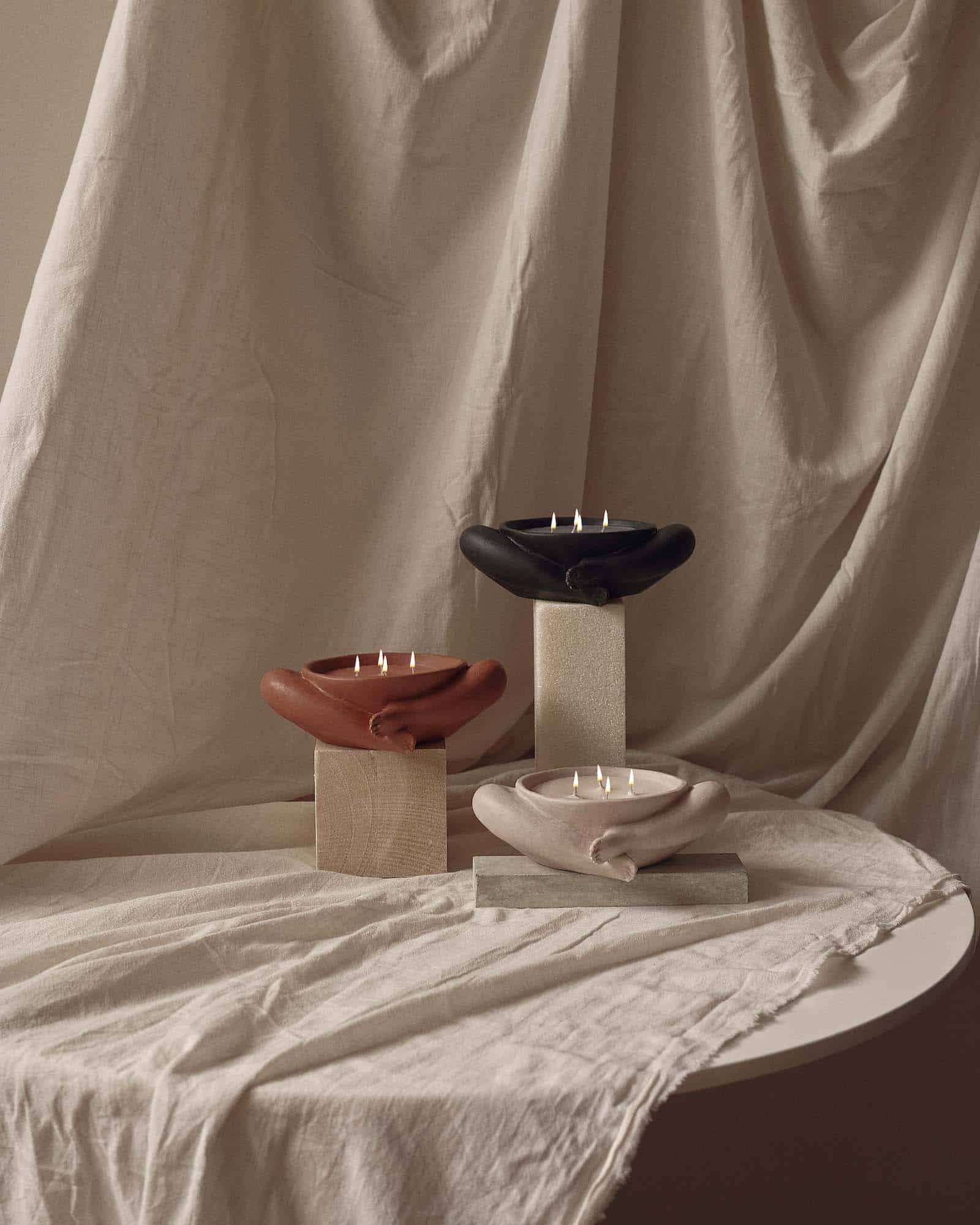 Contemporary Sculptural Candle in Resin and Stone – Biblichor by Marcela Cure — top view of candles on textured fabric